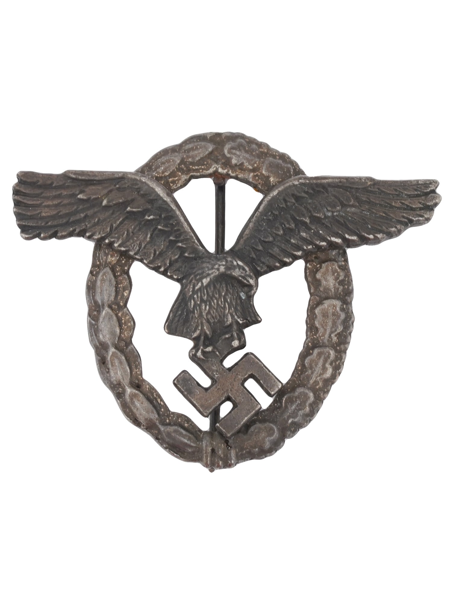 WWII NAZI GERMAN THIRD REICH PILOT OBSERVER BADGE: A World War II Nazi German Third Reich Pilot Observer badge. The badge features a relief wreath of laurel and oak leaves and image of a flying eagle with swastika in its talons. Second World War Histo