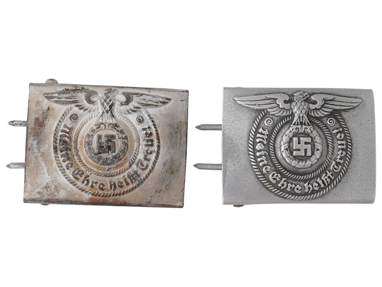 PAIR OF WWII NAZI GERMAN ALUMINUM BELT BUCKLES: A pair of World War II Nazi German aluminum belt buckles. Both have Reichsadler with swastika and inscription Meine Ehre heisst Treue, Loyalty is My Honour, the moto of the SS. Hallmark RZM is on the 