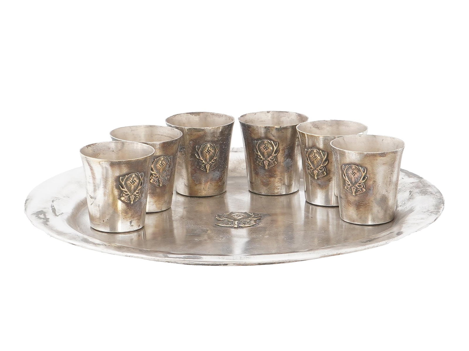GERMAN WWII TYPE HUNTING SCHNAPPS CUPS AND TRAY SET: A WWII type Nazi German set of six Nazi hunting society schnapps cups and a tray, making a total of seven items in the group. The schnapps cups and the tray are adorned with insignia related to the Na