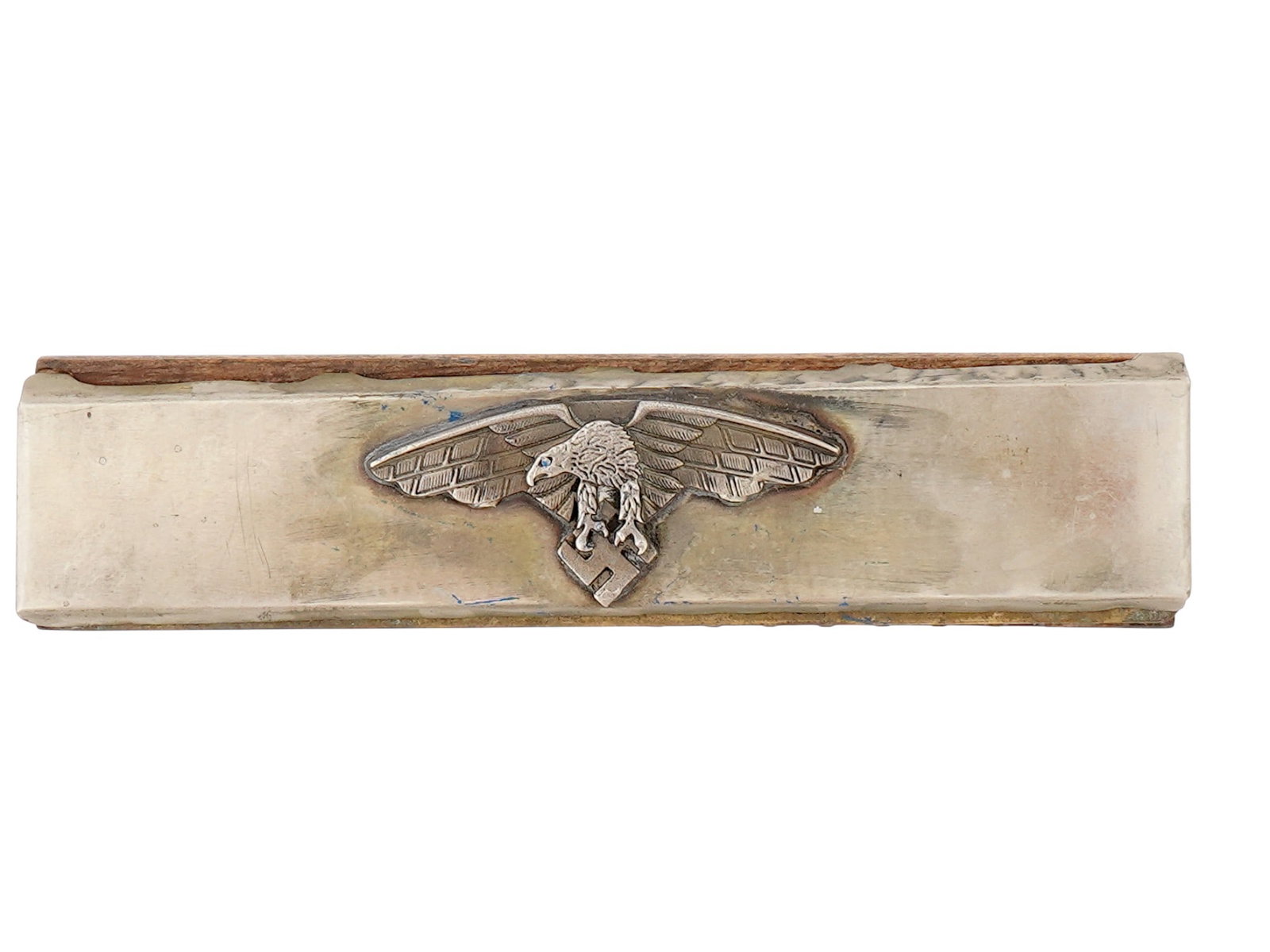 GERMAN WWII MODEL LUFTWAFFE PILOT HARMONICA: A WWII Nazi German Third Reich period model harmonica of a Luftwaffe pilot. Metal construction. The ware is adorned with an overlay representing a Nazi eagle clutching a swastika insignia. Features th