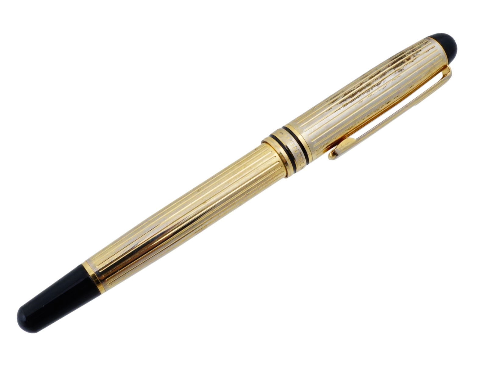 VINTAGE MONTBLANC MEISTERSTUCK GILT BALLPOINT PEN: A vintage ballpoint pen by Montblanc. Meisterstuck collection. Gilt body in fluted pattern with black resin cap and tip. The cap surmounted by the white star emblem. Twist mechanism. Collectible Luxur
