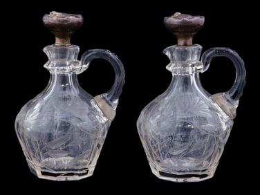 PAIR OF ETCHED GLASS PITCHERS WITH SILVER STOPPERS