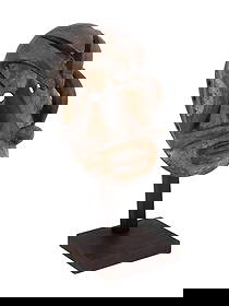 CENTRAL AFRICAN BAULE PEOPLE CARVED WOODEN MASK: A Central African Ivory Coast hand carved wooden mask of Baule people. The mask is a face with round holes for the eyes and skillfully crafted geometric shapes partially covering the face. Through hol