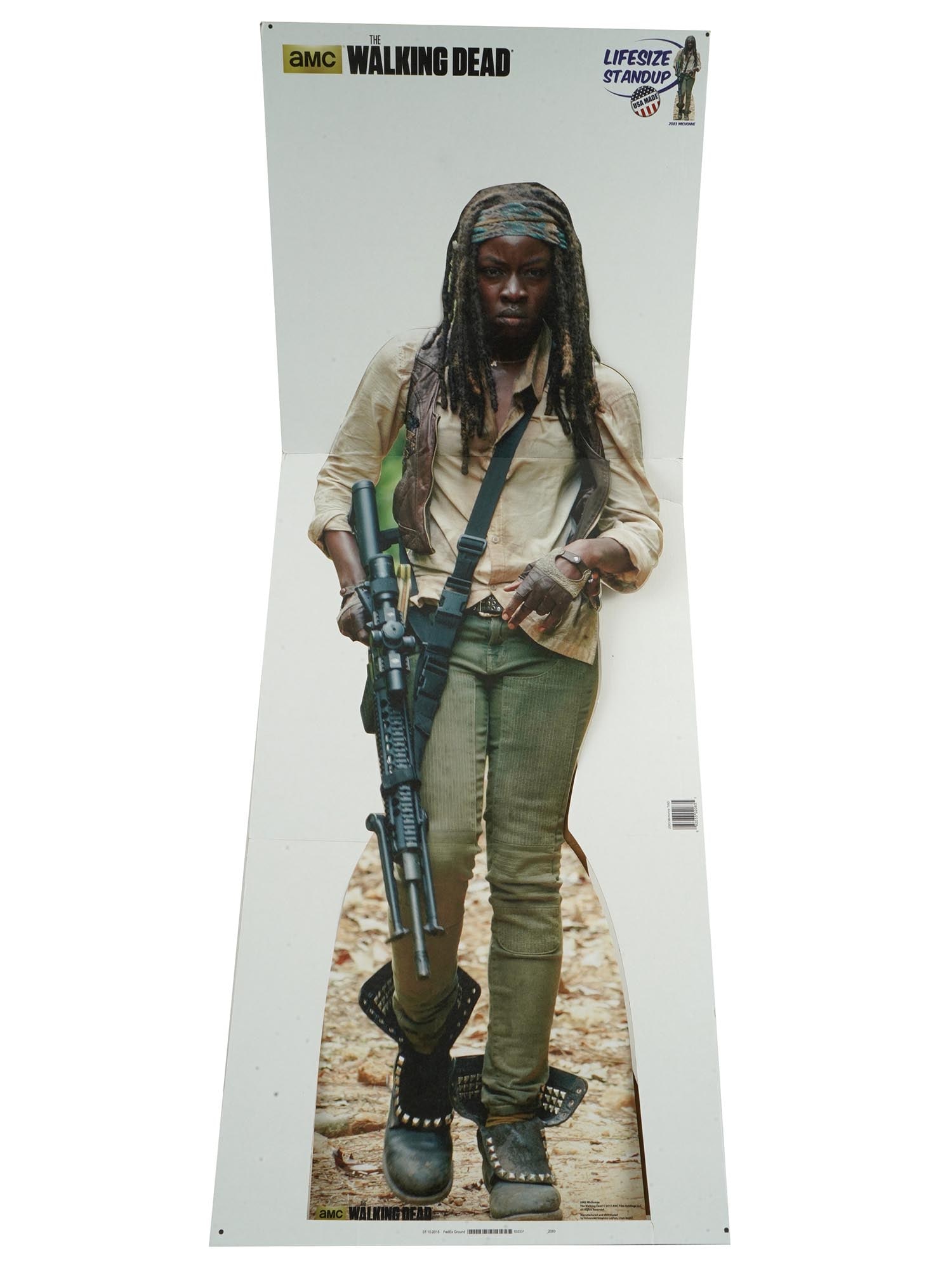WALKING DEAD CHARACTER MICHONNE GRIMES STAND UP POSTER: An American life size stand up folding cardboard poster of the Walking Dead character Michonne Grimes. The movie character is depicted in a combat pose with a weapon in her hands. Manufactured and dis