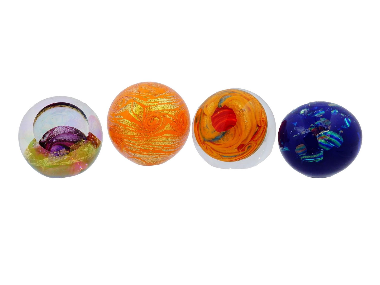 VINTAGE GLASS EYE STUDIO CELESTIAL SERIES PAPERWEIGHTS: A group of four vintage Glass Eye Studio Celestial Series paperweights from the 1990s, featuring planets and celestial bodies such as Jupiter, Venus, the Sun, and more. Inscribed. Vintage Desk Accesso
