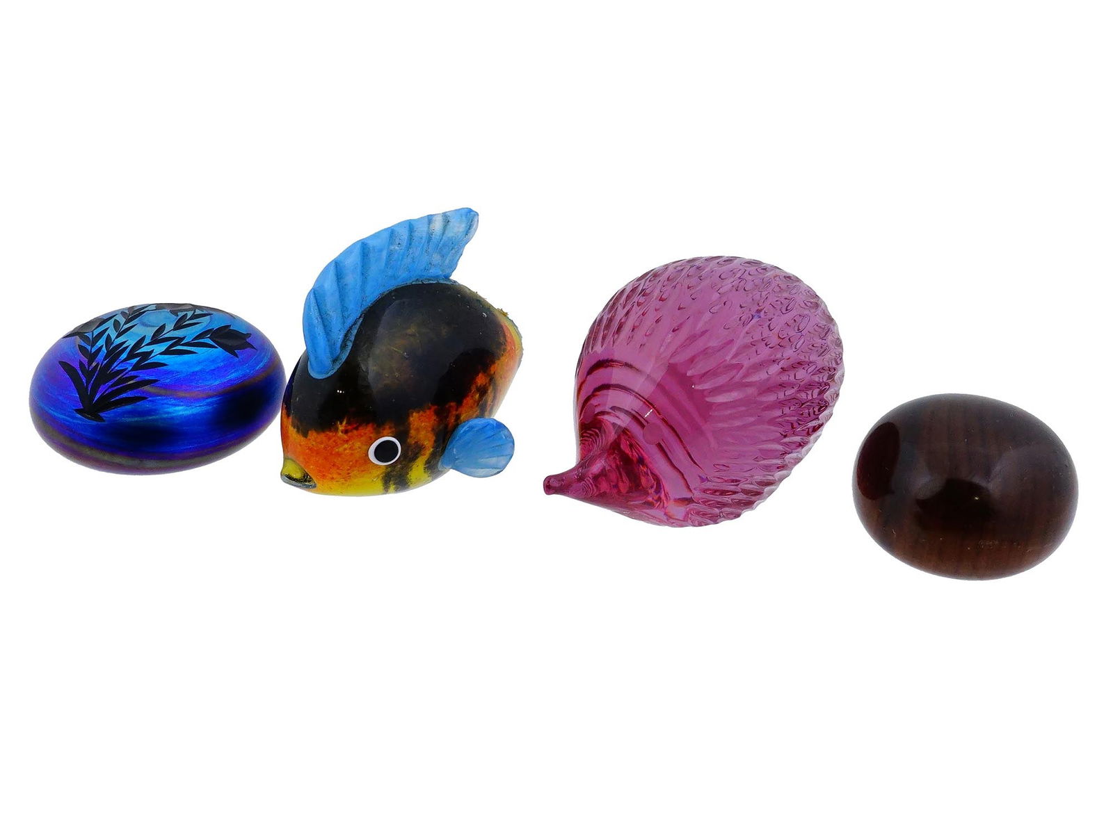VINTAGE MULTICOLORED GLASS PAPERWEIGHTS NATURE DESIGNS: A group of four vintage multicolored glass paperweights, each featuring nature-inspired designs, including fish, flowers, and other organic motifs. Vintage Desk Accessories And Glassware Collectibles.