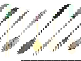 STERLING SILVER FORKS AND SPOONS CUTLERY SET: A sterling silver cutlery set including forks and spoons. A total of five items. The first fork has two prongs, the shaft has a lot of engraving and the handle bears a carved of green stone figurine i