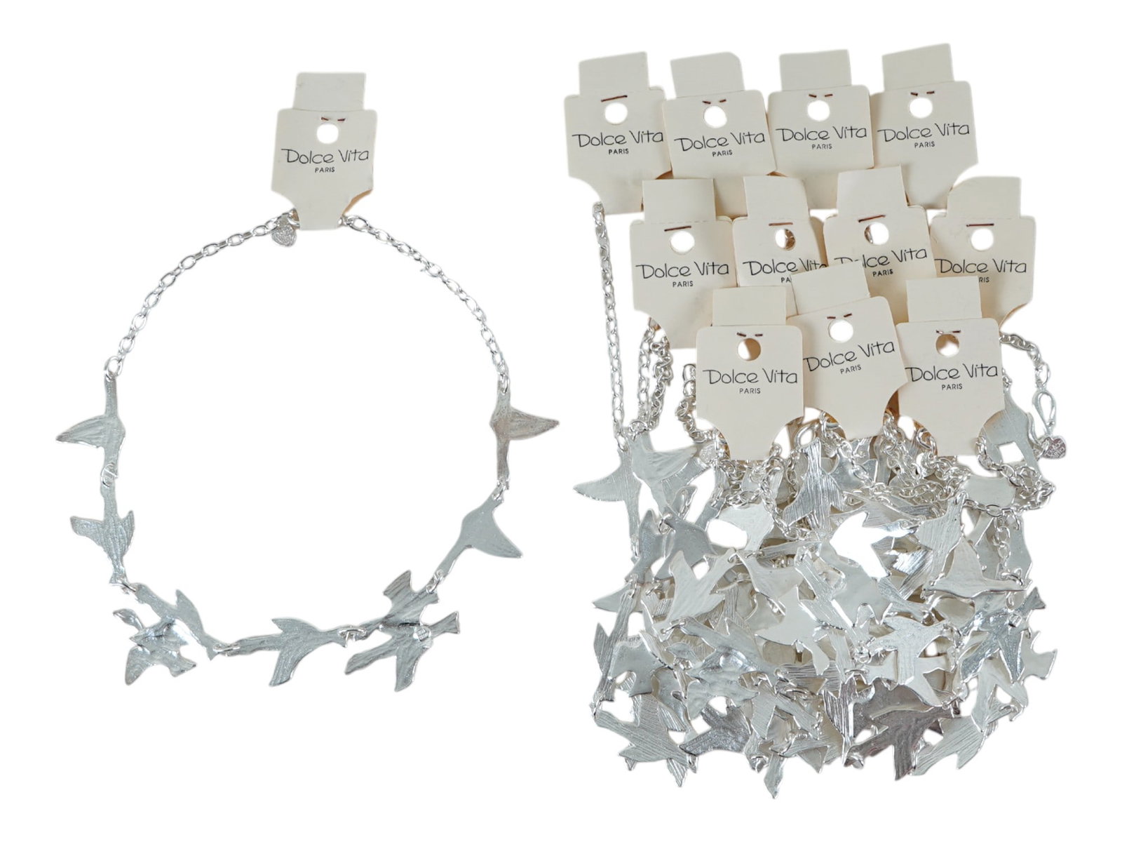 VTG FRENCH DOLCE VITA COSTUME JEWELRY BIRD NECKLACES: A vintage French Dolce Vita costume jewelry set, including 12 silver toned necklaces adorned with multiple birds. Presumably made in the 1980s. Displayed on white cardboard cards, marked with the bran