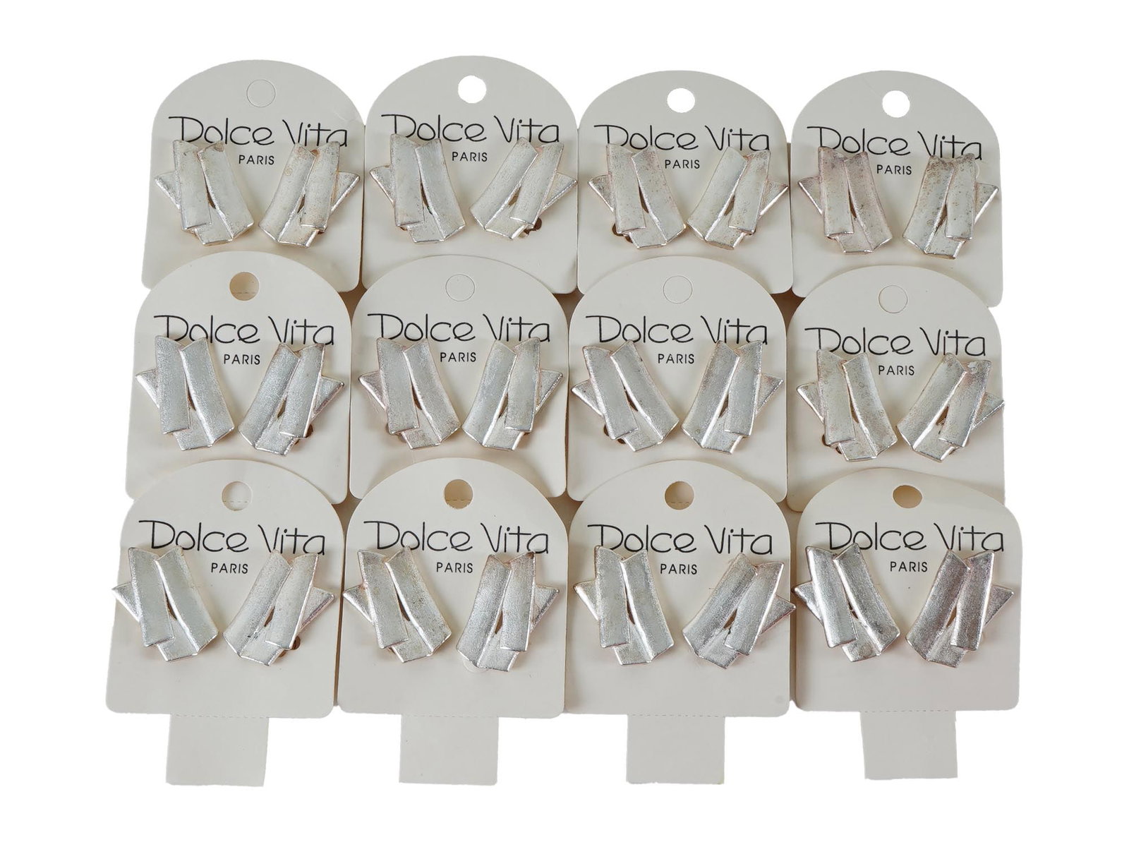 VTG FRENCH DOLCE VITA COSTUME JEWELRY CLIP ON EARRINGS: A vintage French Dolce Vita costume jewelry set, including 12 silver toned geometric textured clip on earrings. Presumably made in the 1980s. Displayed on white cardboard cards, marked with the brands