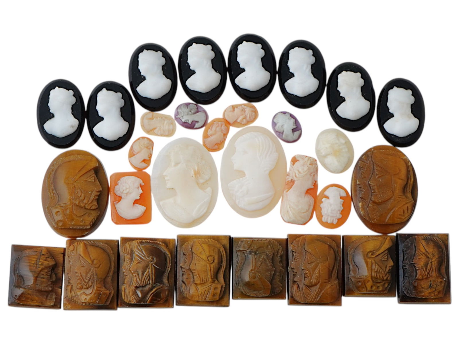 COLLECTION OF ANTIQUE HAND CARVED CAMEOS: A collection of antique hand carved cameos, dating to the late 19th to early 20th century. Each piece is crafted from conch shell and stone, featuring knights in armor and female portraits rendered in