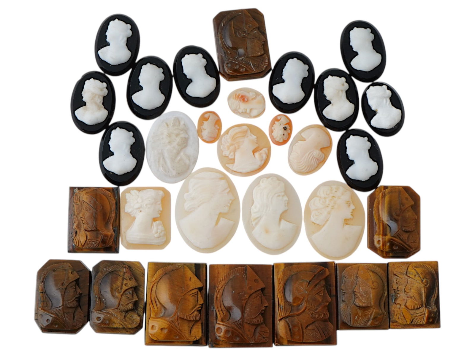 COLLECTION OF ANTIQUE HAND CARVED CAMEOS: A collection of antique hand carved cameos, dating to the late 19th to early 20th century. Each piece is crafted from conch shell and stone, featuring knights in armor and female portraits rendered in
