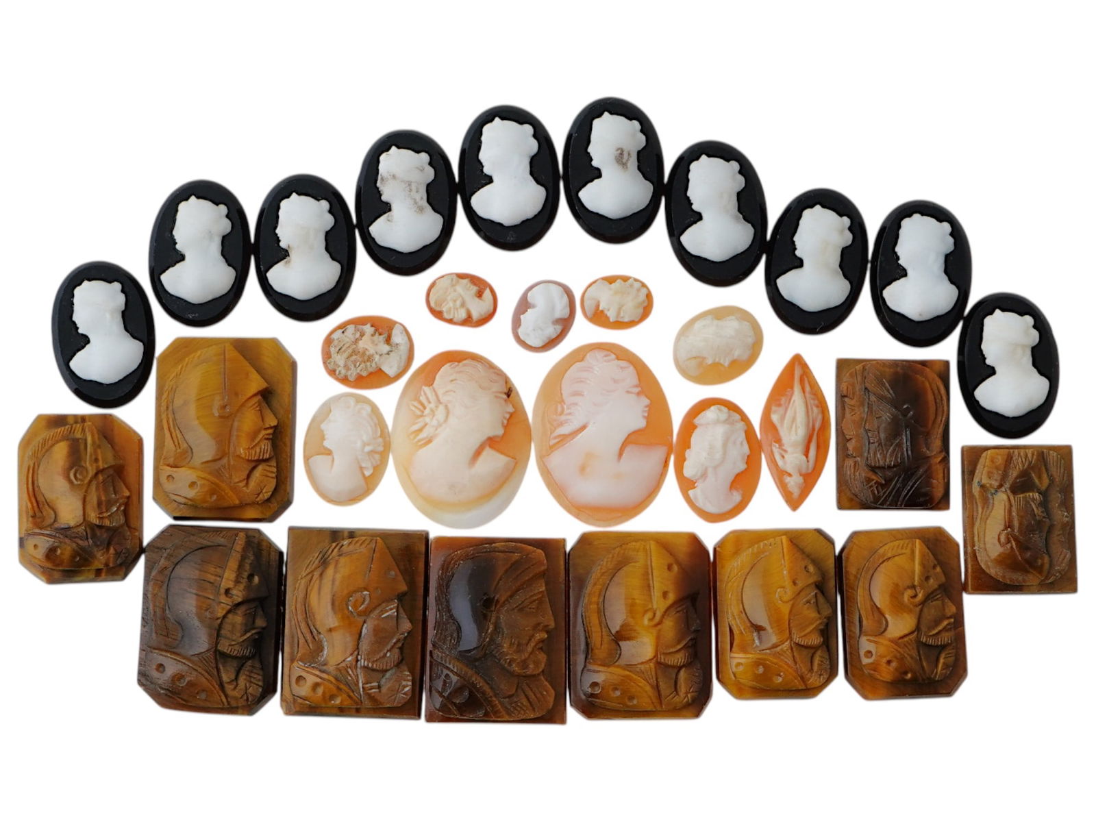 COLLECTION OF ANTIQUE HAND CARVED CAMEOS: A collection of antique hand carved cameos, dating to the late 19th to early 20th century. Each piece is crafted from conch shell and stone, featuring knights in armor and female portraits rendered in