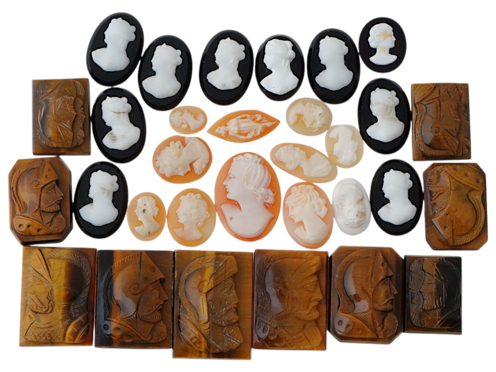 COLLECTION OF ANTIQUE HAND CARVED CAMEOS: A collection of antique hand carved cameos, dating to the late 19th to early 20th century. Each piece is crafted from conch shell and stone, featuring knights in armor and female portraits rendered in