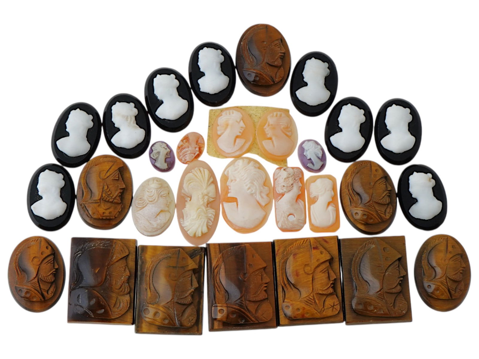 COLLECTION OF ANTIQUE HAND CARVED CAMEOS: A collection of antique hand carved cameos, dating to the late 19th to early 20th century. Each piece is crafted from conch shell and stone, featuring knights in armor and female portraits rendered in
