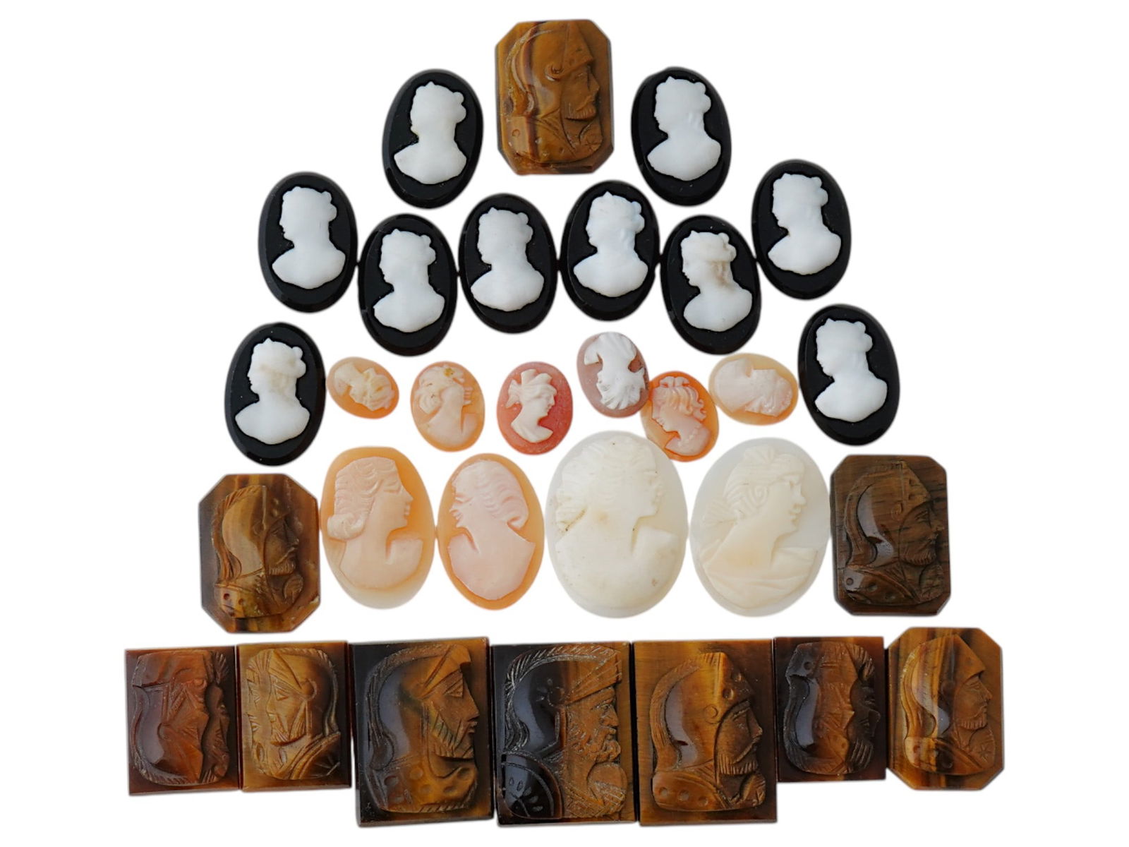 COLLECTION OF ANTIQUE HAND CARVED CAMEOS: A collection of antique hand carved cameos, dating to the late 19th to early 20th century. Each piece is crafted from conch shell and stone, featuring knights in armor and female portraits rendered in