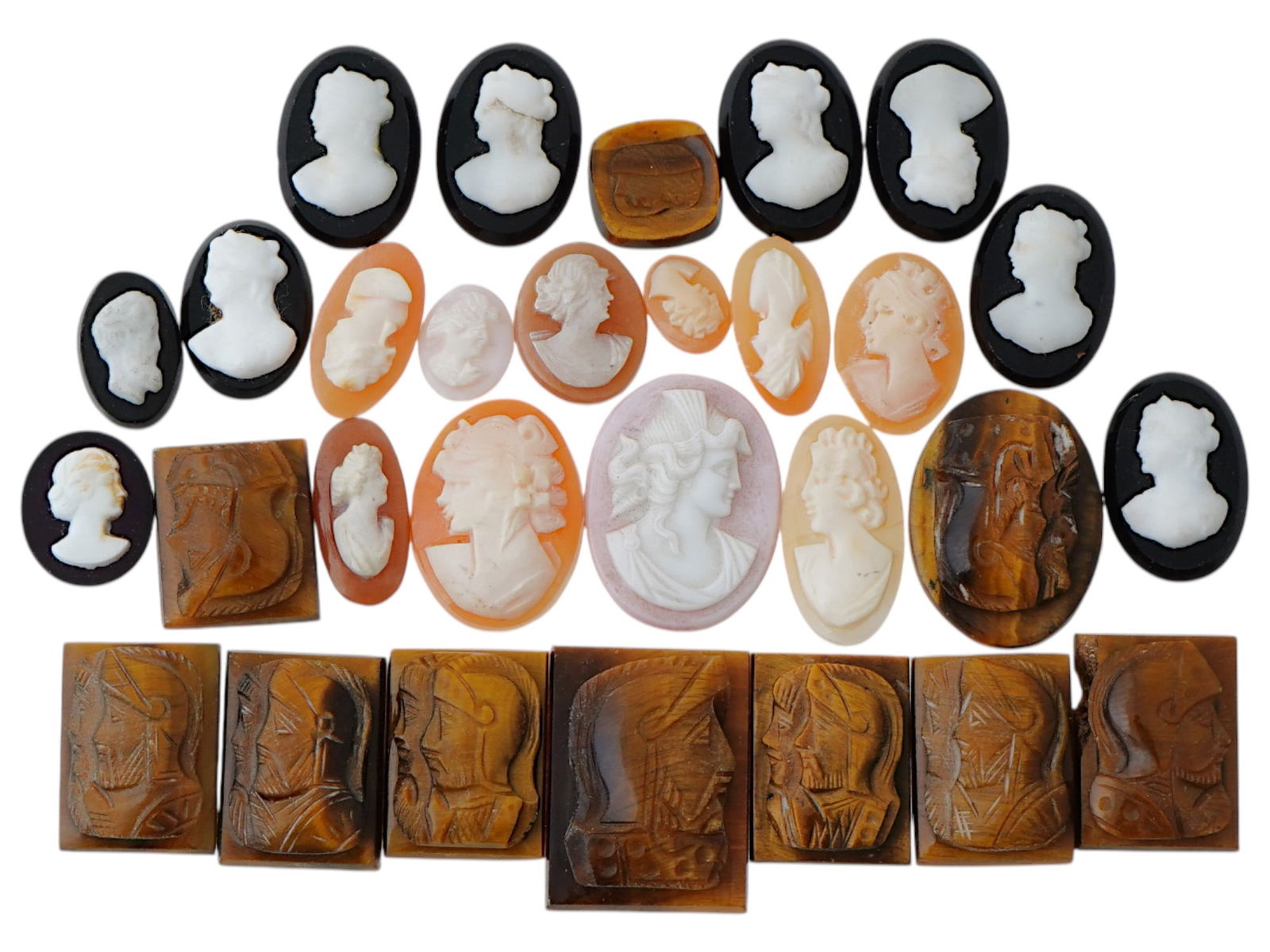 COLLECTION OF ANTIQUE HAND CARVED CAMEOS: A collection of antique hand carved cameos, dating to the late 19th to early 20th century. Each piece is crafted from conch shell and stone, featuring knights in armor and female portraits rendered in