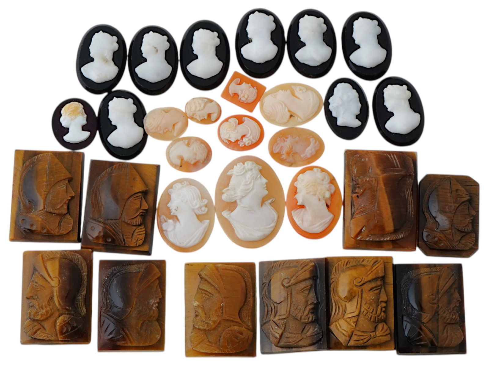 COLLECTION OF ANTIQUE HAND CARVED CAMEOS: A collection of antique hand carved cameos, dating to the late 19th to early 20th century. Each piece is crafted from conch shell and stone, featuring knights in armor and female portraits rendered in