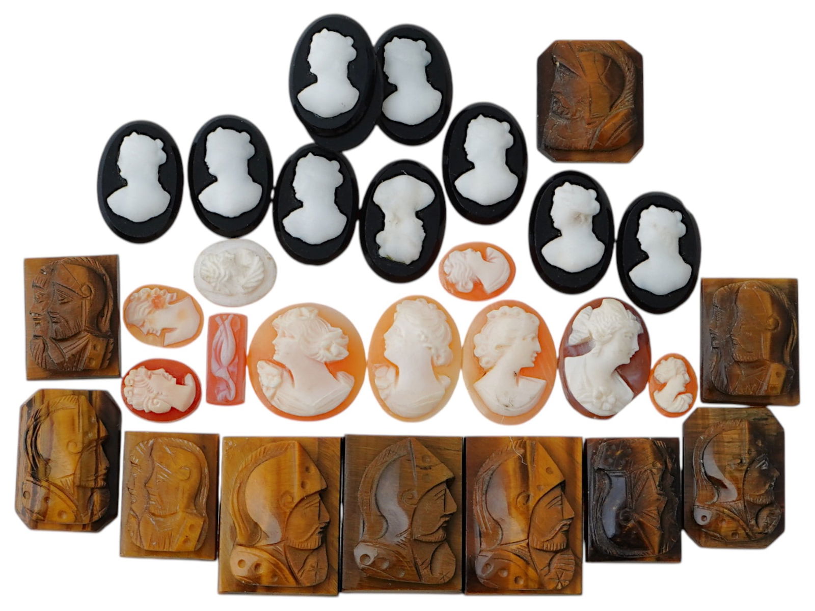COLLECTION OF ANTIQUE HAND CARVED CAMEOS: A collection of antique hand carved cameos, dating to the late 19th to early 20th century. Each piece is crafted from conch shell and stone, featuring knights in armor and female portraits rendered in