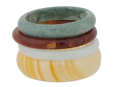 COLLECTION OF CARVED JADE AND STONE BANGLE BRACELETS