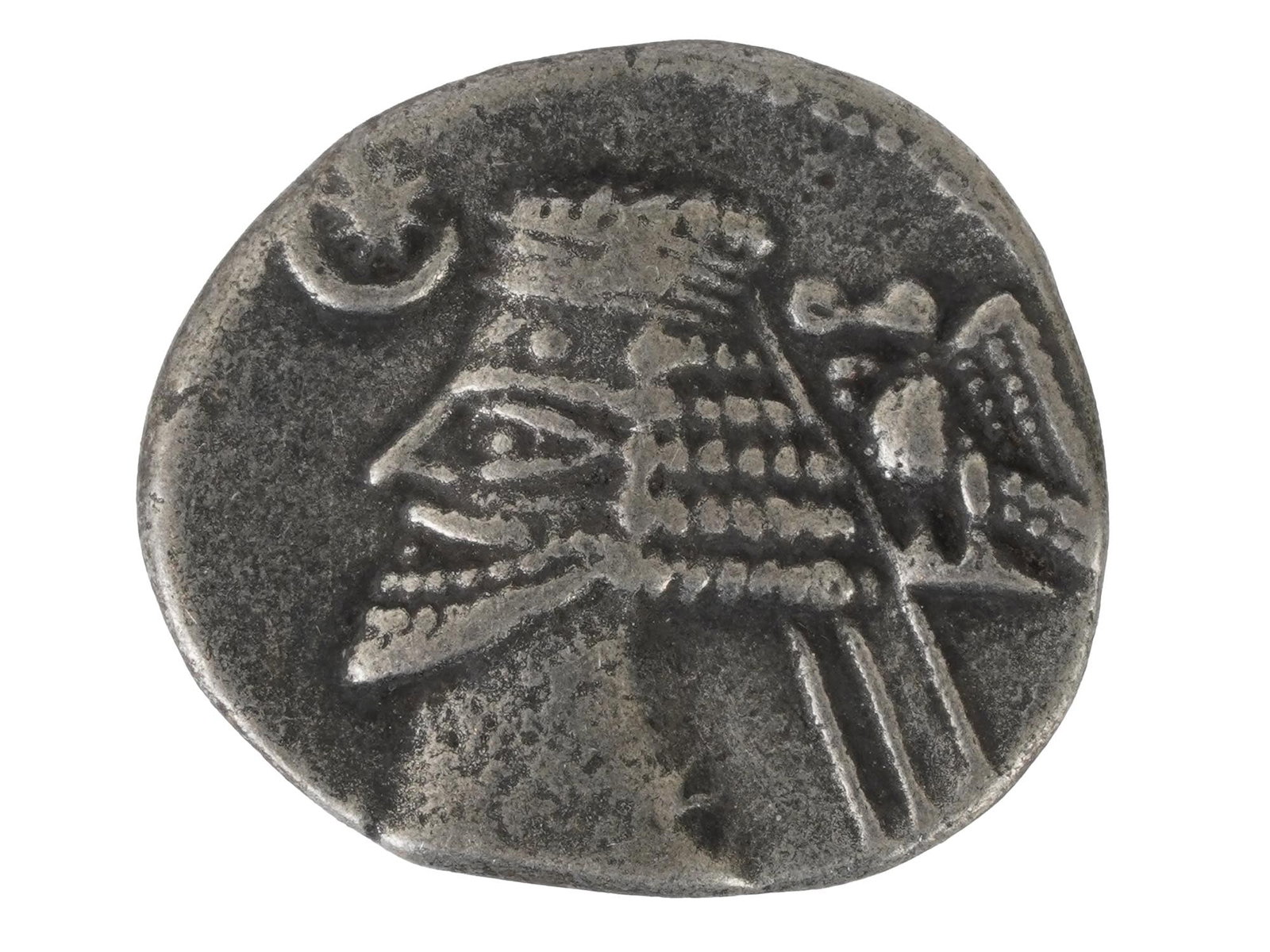 ANCIENT PERSIAN PARTHIAN SILVER DRACHM COIN: An ancient Persian Parthian Empire silver drachm coin with a portrait of the King on the front. The reverse side of the coin depicts a seated archer with Greek inscriptions. Circa: 247 BC to 228 AD. I