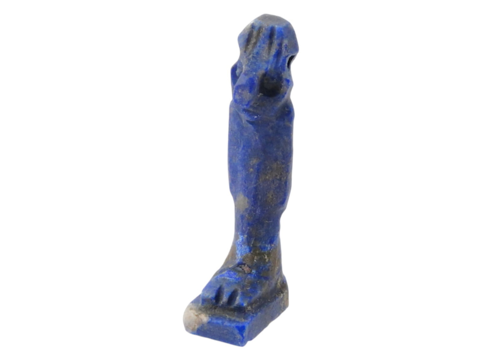 ANCIENT EGYPTIAN PTOLEMAIC LAPIS LAZULI HORUS PENDANT: An ancient Egyptian lapis lazuli amulet pendant from the Ptolemaic Period, 305 to 30 BC, carved in the form of the falcon-headed god Horus. The piece is pierced through the crown for wearing, serving 