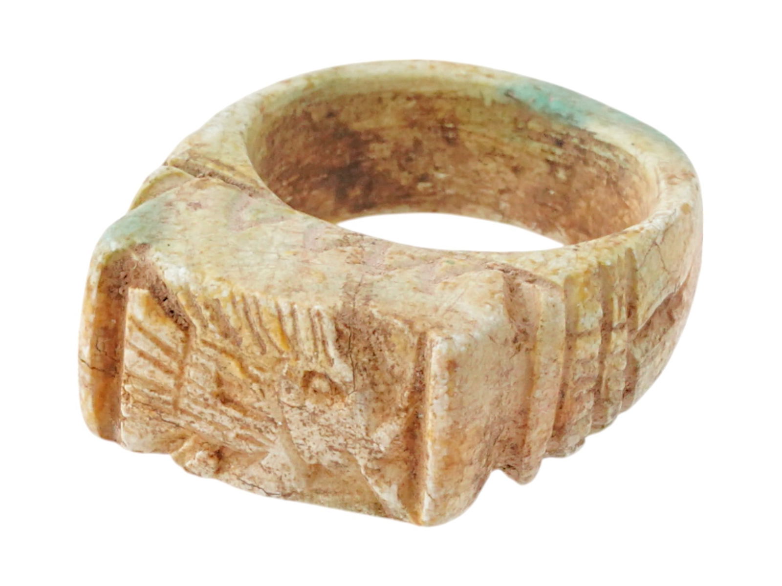 ANCIENT EGYPTIAN PTOLEMAIC DYNASTY STONE RING: An ancient Egyptian Ptolemaic Dynasty carved stone ring. The ring is adorned with an engraved fish design on the front and a linear motif on the sides. Circa: 305 to 30 BC. Size 8.5. Ancient Carved Na