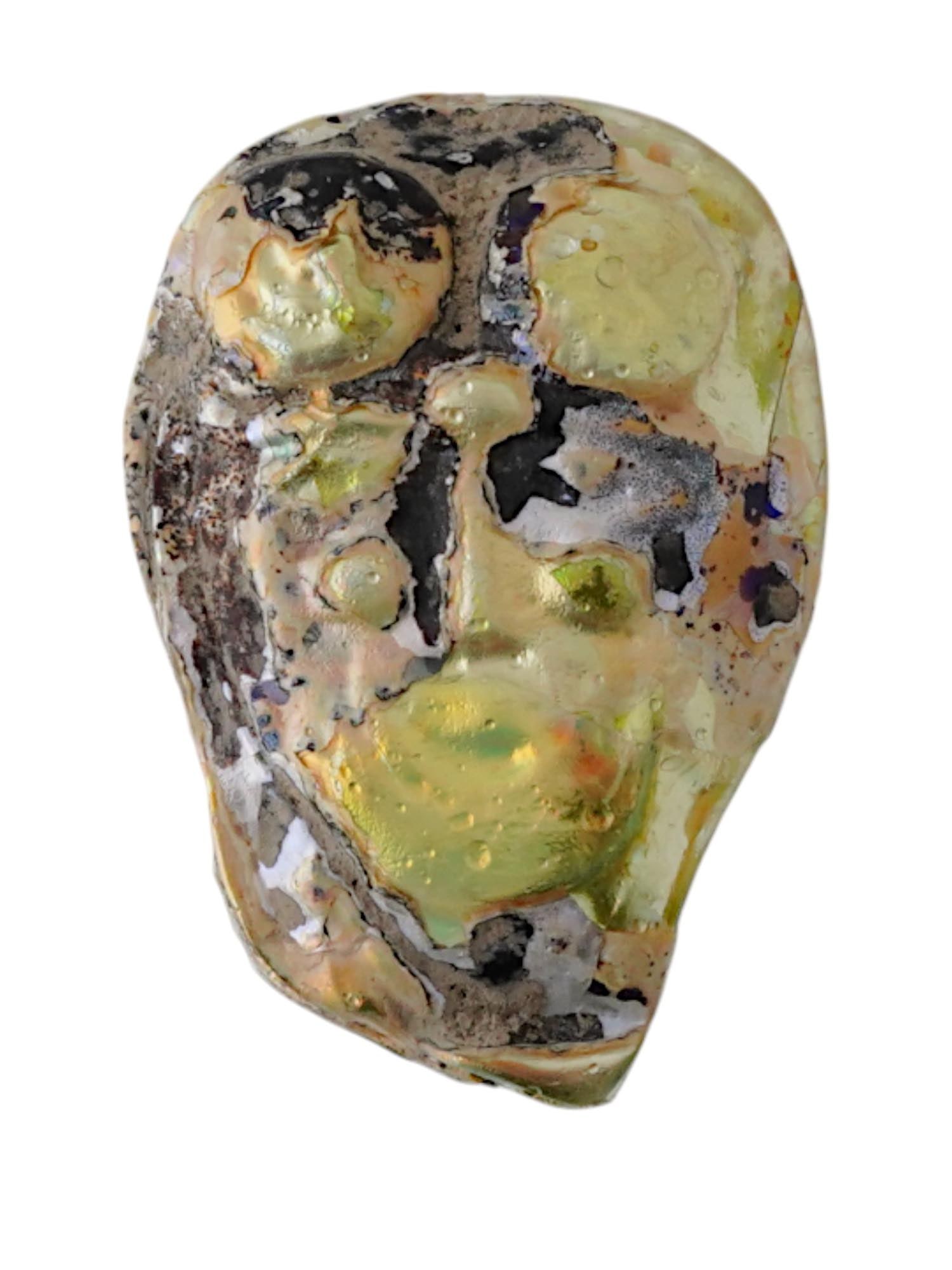 ANCIENT PERSIAN GLASS INLAY FRAGMENT OF A STYLIZED FACE: An ancient Persian glass inlay fragment depicting a stylized face, dating to circa 200 BC. Formed in glass with surviving traces of iridescence and surface encrustation, this piece reflects the skille