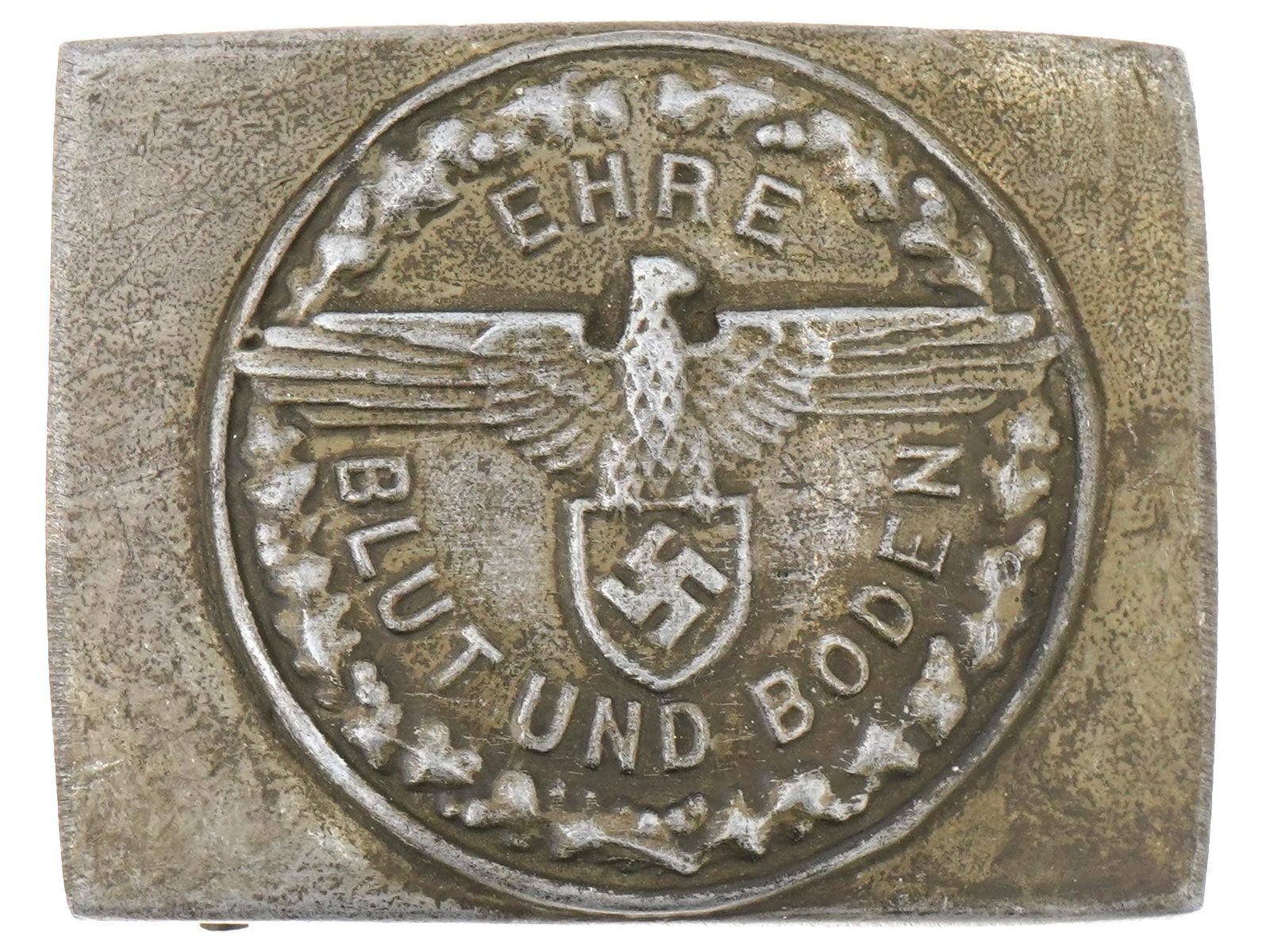WWII GERMAN SS FREIWILLIGE SCHUTZSTAFFEL BELT BUCKLE: A WWII type Nazi German Freiwillige Schutzstaffel Volunteer Forces of Slovakia belt buckle. Square buckle with embossed depictions of the Reichsadler, swastika, and inscription Ehre Blut Und Boden. Se