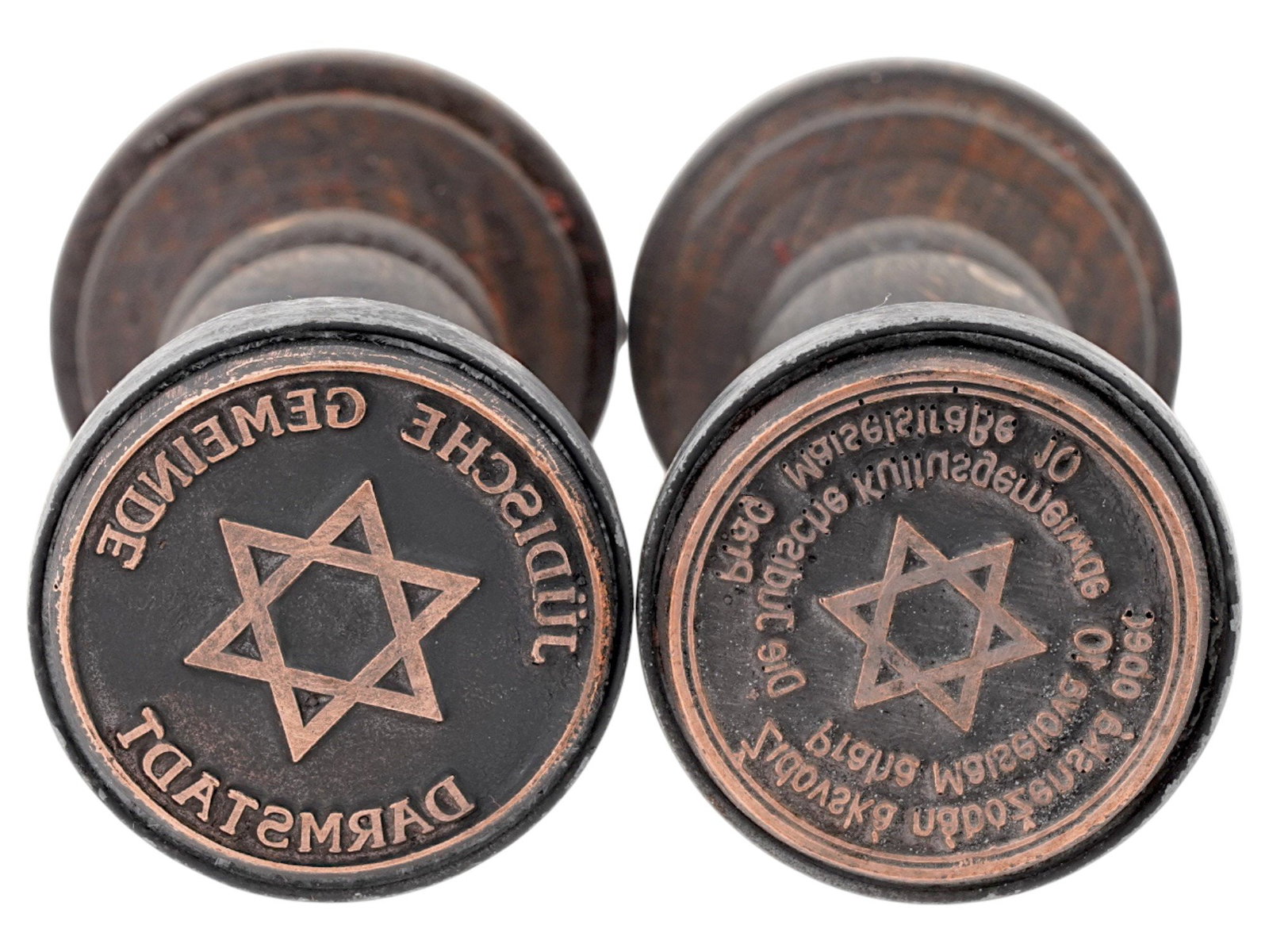 GROUP OF TWO WWII TYPE HOLOCAUST PERIOD HAND STAMPS: A group of two WWII type Holocaust period hand stamps from different Ghettos. The lot includes Prague Ghetto, and Darmstadt Ghetto. Each stamp is decorated with the Star of David design and inscribed 