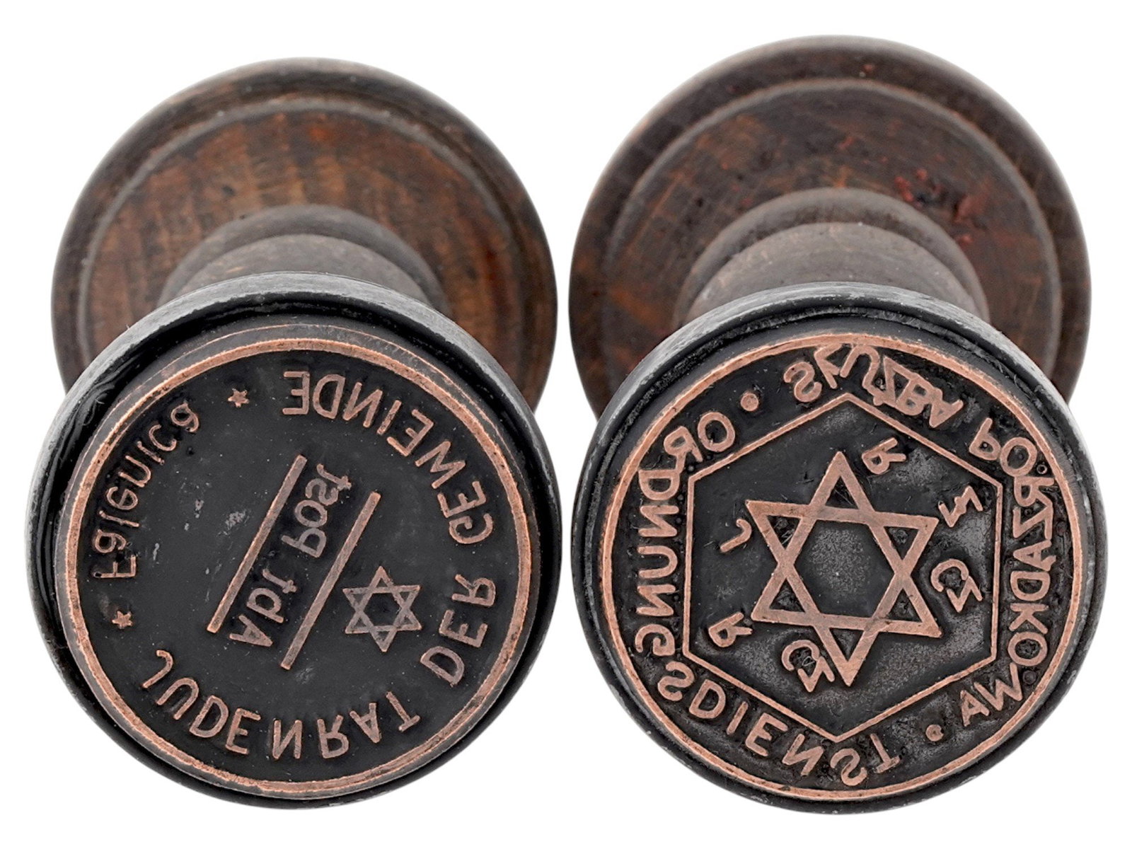 TWO WWII HOLOCAUST WARSAW GHETTO HAND STAMPS: A group of two WWII Holocaust Warsaw Ghetto hand stamps, both round in form. These stamps were used for administrative or identification purposes within Nazi-occupied territories or Jewish ghettos. Se