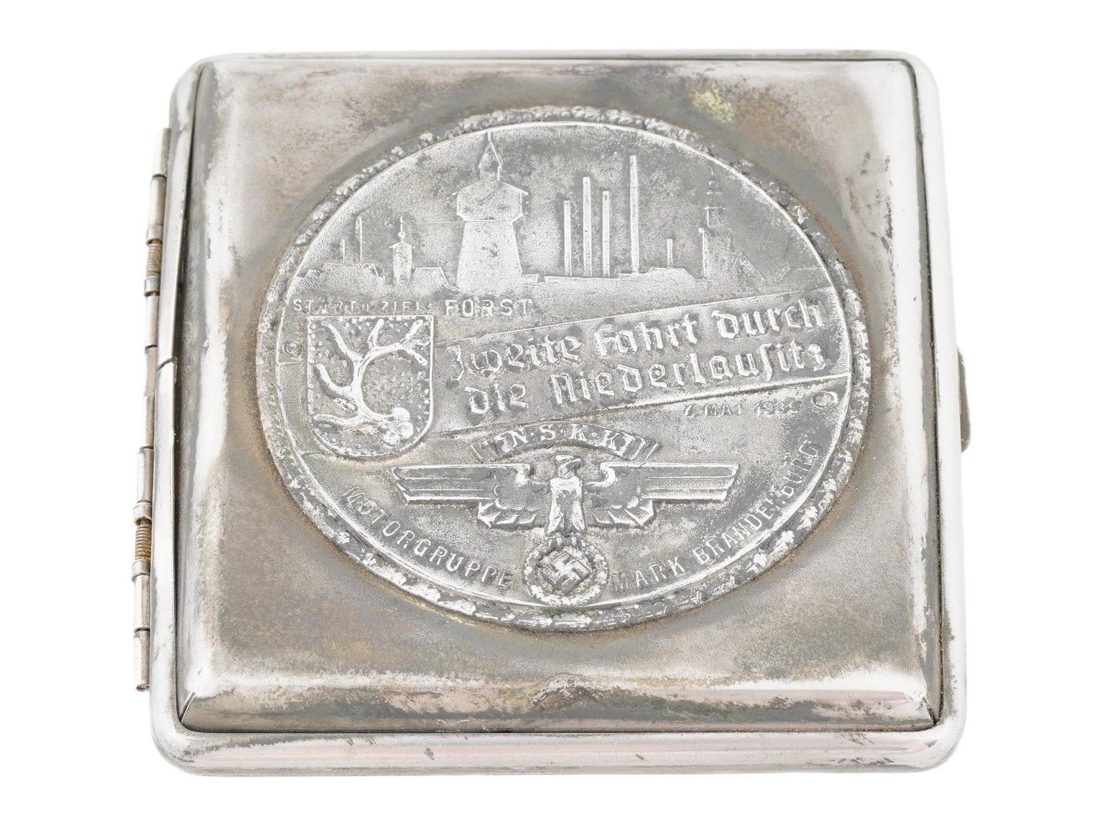 GERMAN WWII TYPE NSKK MOTORCYCLE CLUB CIGARETTE CASE: A WWII model Nazi German Third Reich NSKK Motorgruppe Motorcycle Club Mark Brandenburg cigarette case. The case is metal alloy construction. The case is adorned with a metal plaque featuring an image 