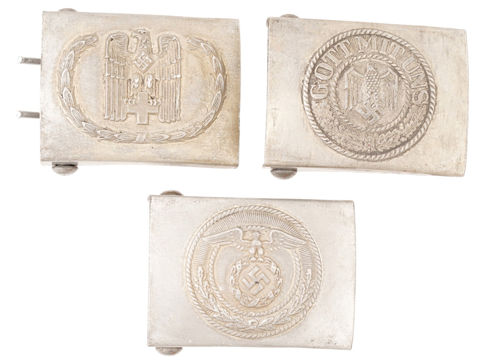 WWII MODEL GERMAN SA ARMY AND RED CROSS BELT BUCKLES: A group of three WWII model German belt buckles: SA, Army and Red Cross. The first features an eagle clutching a cross, surrounding by a wreath. The second has an emblem with the text GOTT MIT UNS and