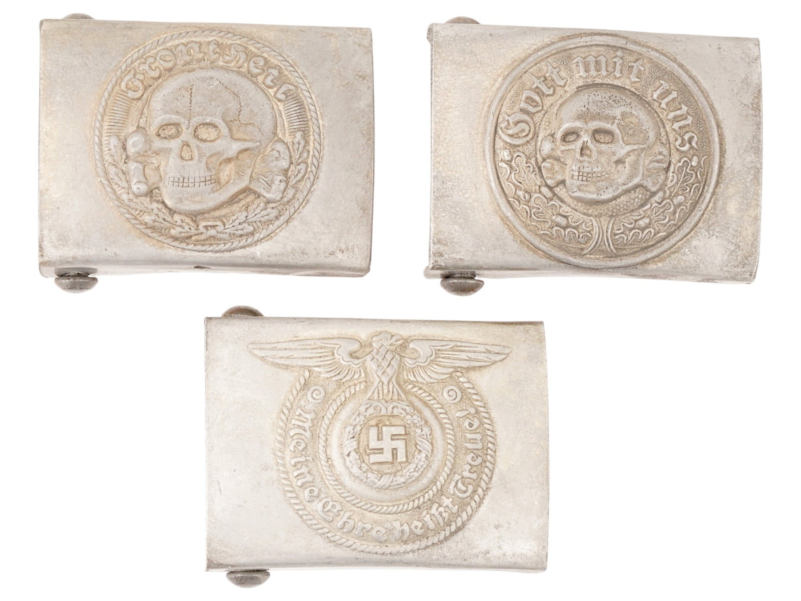 GROUP OF THREE WWII MODEL GERMAN SS BELT BUCKLES: A group of three WWII model German SS belt buckles: SS EM and SS Totenkopf. Two bears a relief image of a Totenkopf skull swastika insignia and the motto in German, God with Us, featuring a relief ima