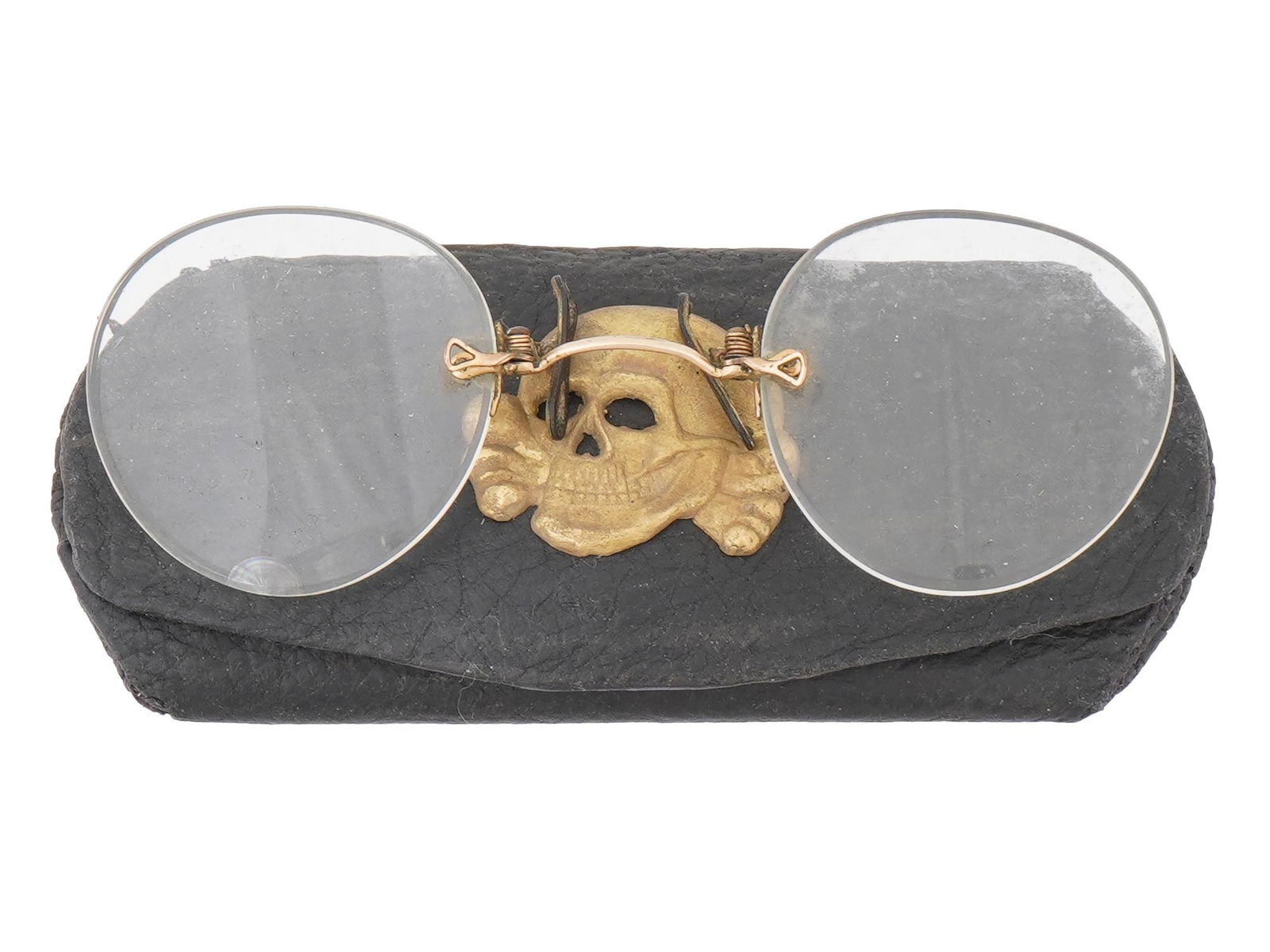 WWII STYLE GERMAN GLASSES WITH TOTENKOPF CASE: A pair of World War II style German eye glasses. Pincenez type, oval shape, metal frame. The glasses come in a leather case decorated with overlay SS Totenkopf emblem. Second World War Historical Coll