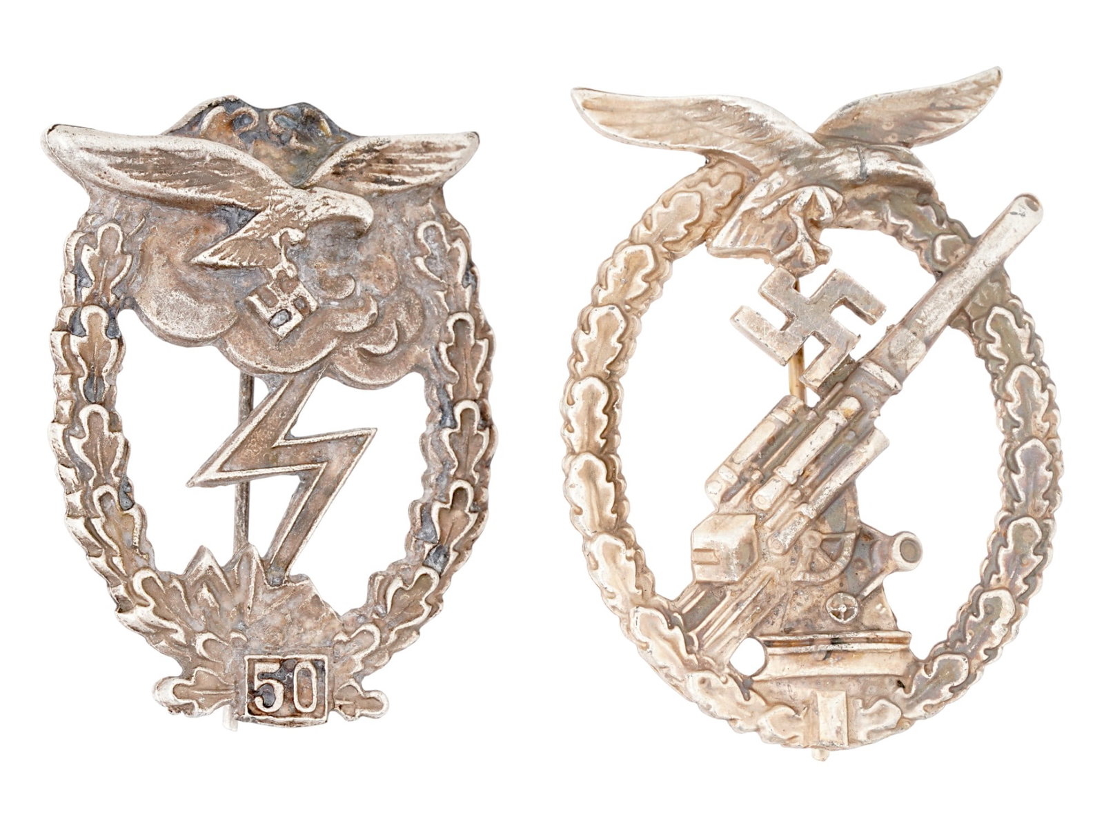 WWII TYPE NAZI GERMAN LUFTWAFFE ANTI AIRCRAFT BADGES: A lot of WWII model Nazi German Luftwaffe badges. The first: an Anti Aircraft Flak Battle badge featuring a Luftwaffe eagle at the top, and an oak leaf wreath around the outside rim. In the middle is 