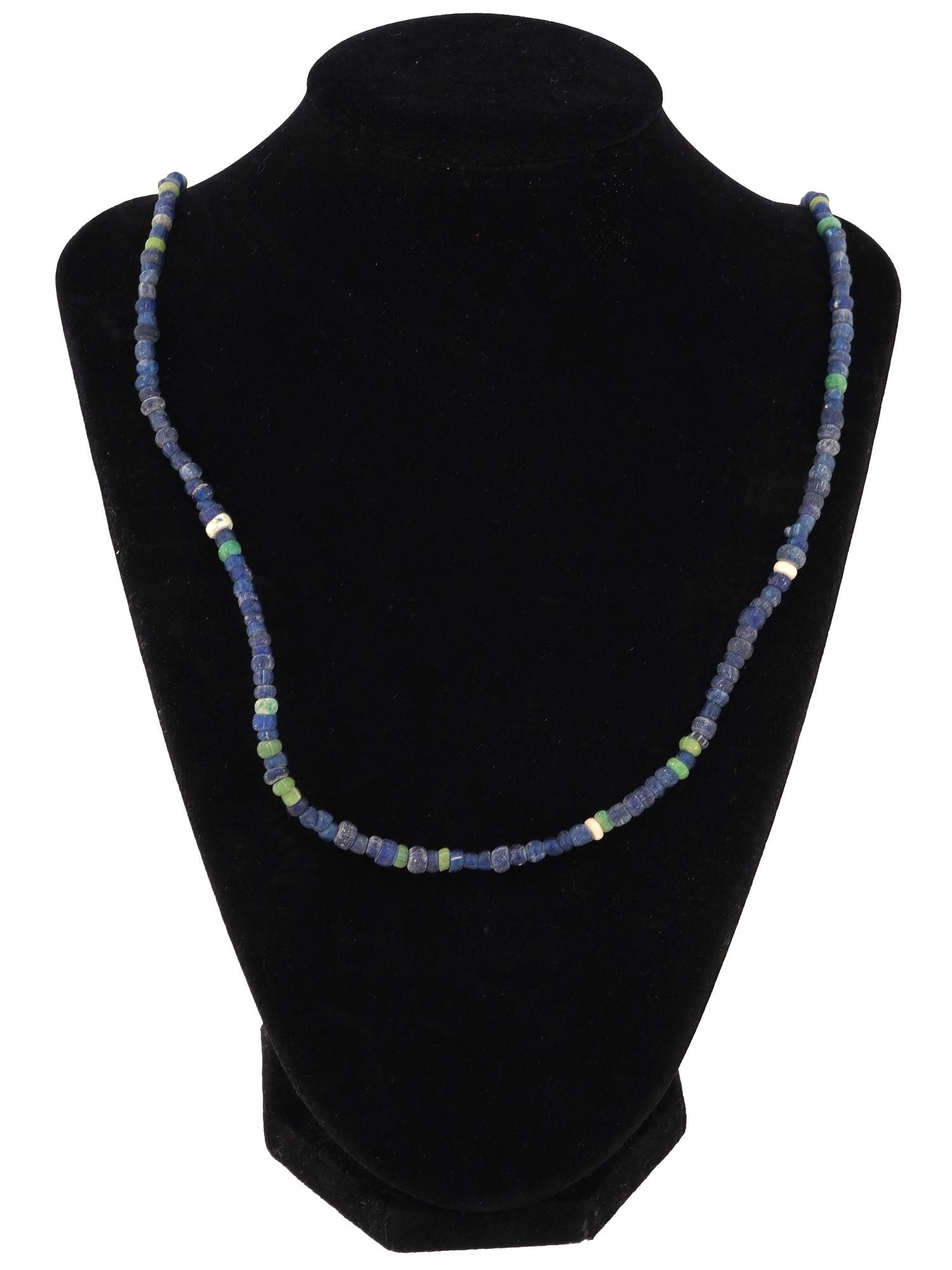 ANCIENT ROMAN GLASS BEAD NECKLACE 100 TO 300 AD: An ancient Roman glass bead necklace dating from 100 to 300 AD. Features a colored glass beads, mostly in blue shade with a few green beads, exemplifying the craftsmanship and artistry of Roman glassm