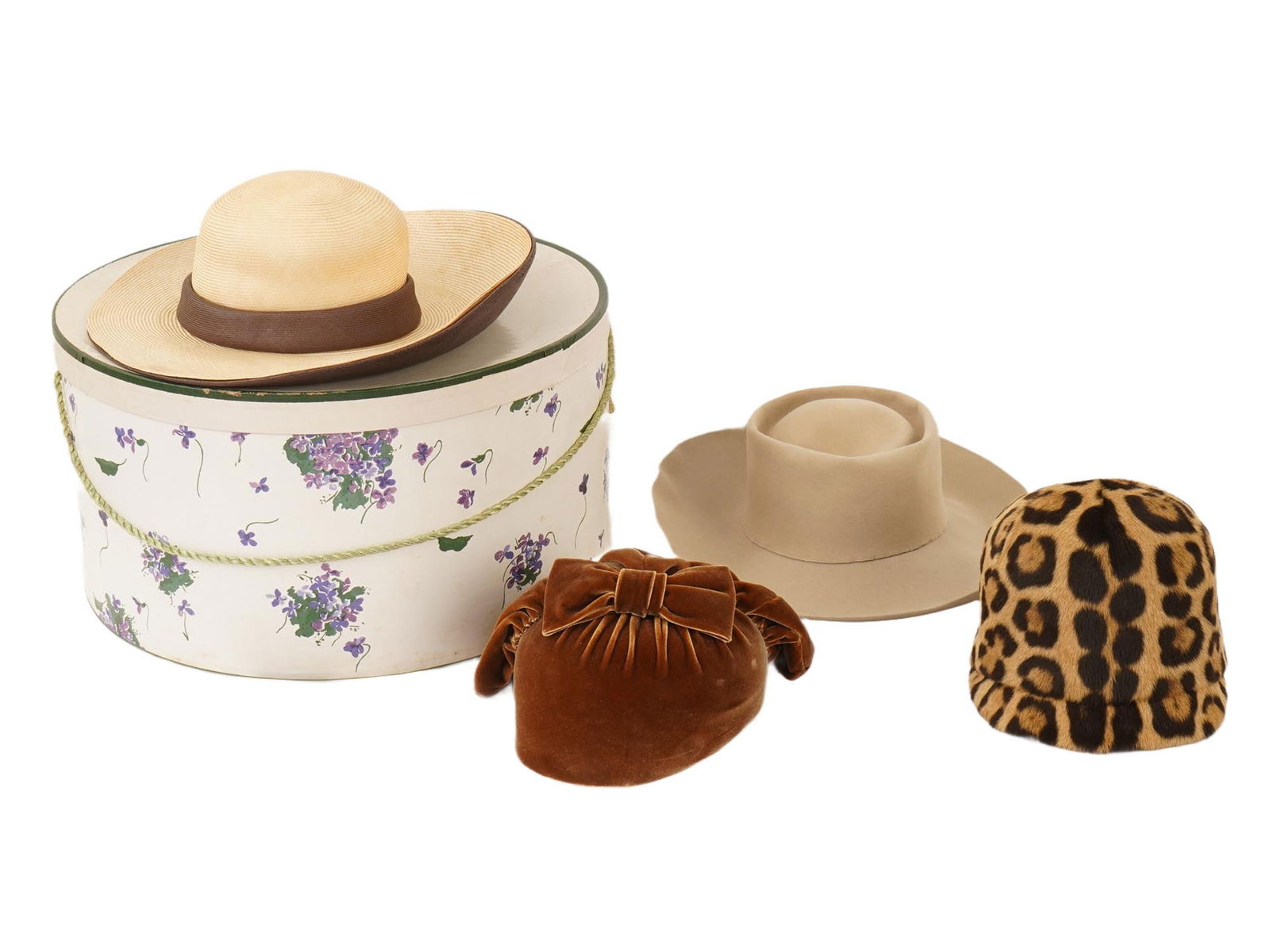 LOT OF MID CENTURY BONWIT TELLER WOMENS HATS IOB: A lot of four vintage womens hat from Bonwit Teller and Henri Bendel. Straw-type hat. Beige felt hat with wide brim. Leopard fur cloche hat. Brown velvet hat with a ribbon by Gilbert Orcel. The hats c