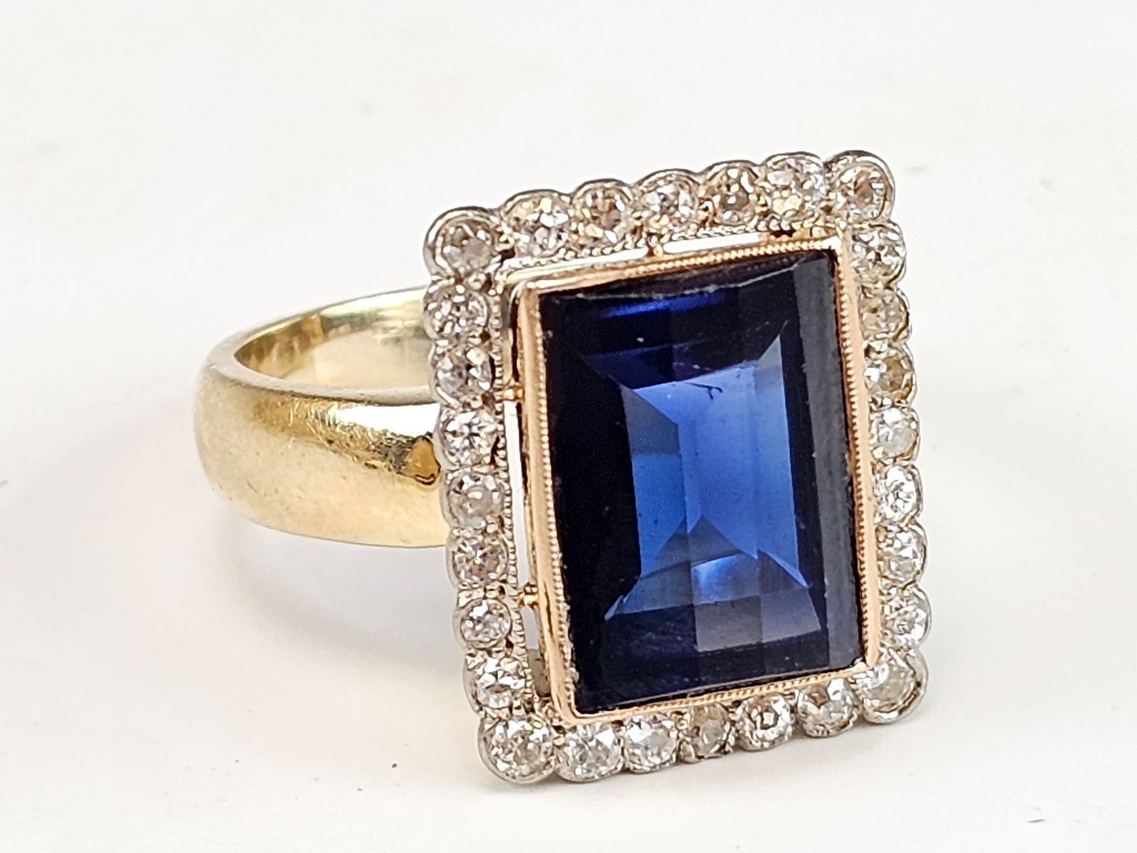 ANTIQUE RUSSIAN 14K GOLD SAPPHIRE DIAMONDS RING: An antique Russian 14K yellow gold ring featuring a large sapphire stone at the center, approximately 5 carats, surrounded by approximately 28 diamonds totaling 1 carat. The ring is hallmarked with a
