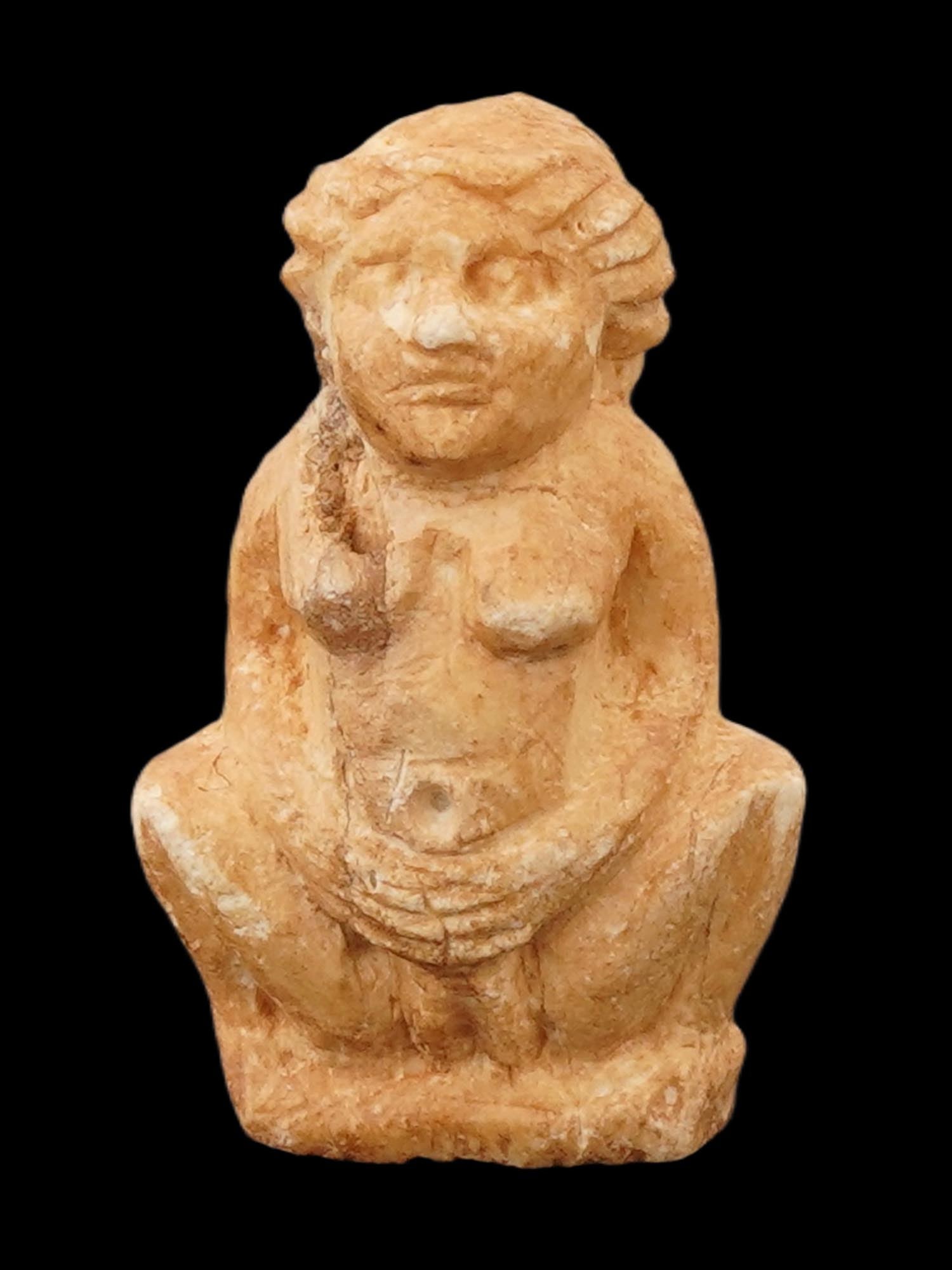 ANCIENT EGYPTIAN EROTIC FERTILITY GODDESS PENDANT: An ancient Egyptian pottery sculptural pendant. The pendant depicts an erotic seated figure representing fertility goddess, engraved with detailed patterns and facial features with spread legs. Circa: