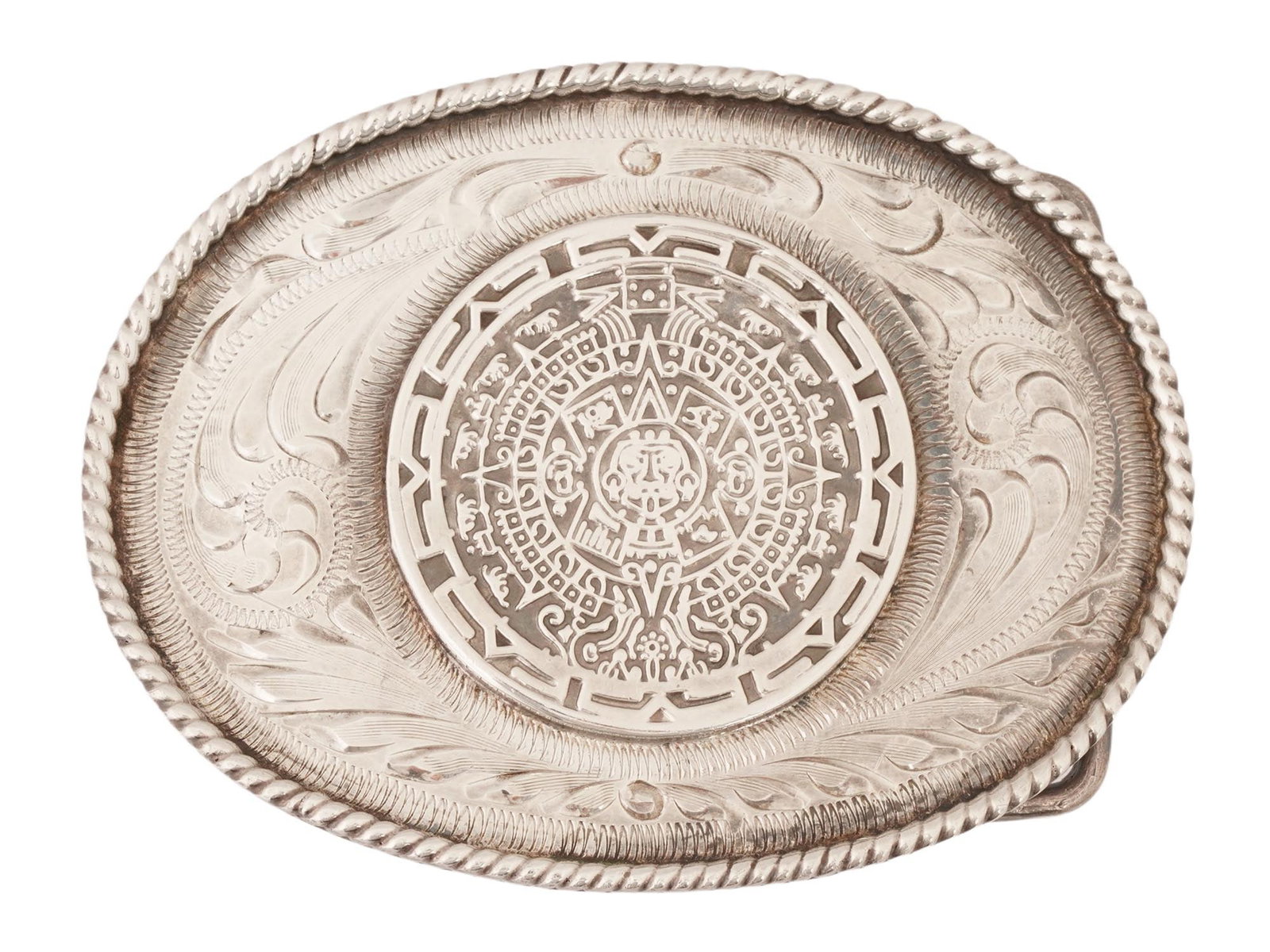 TAXCO MEXICAN CALENDAR STERLING SILVER BELT BUCKLE: A Taxco Mexican Sterling Silver statement belt buckle. The oval shaped ware is adorned with an engraved calendar design. Marked with a Sterling Silver standard hallmark, and impressed stamps, on the b