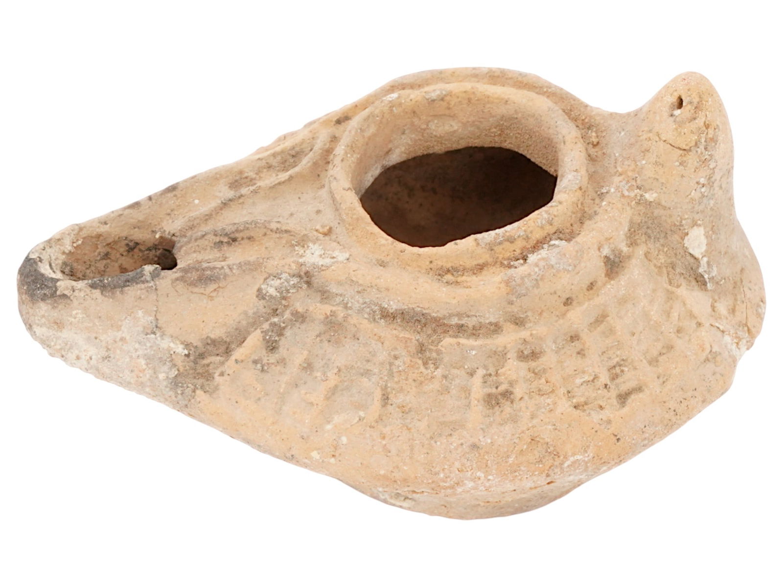 ANCIENT BYZANTINE TERRACOTTA OIL LAMP 400 TO 600 AD: An ancient Byzantine Empire moulded terracotta pottery oil lamp, known as a slipper lamp. The body of the lamp is adorned with engraved ornaments. The lamp is decorated with a raised circle nozzle top