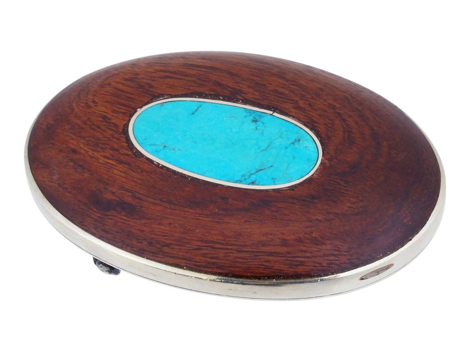VINTAGE METAL AND WOOD BELT BUCKLE W TURQUOISE: A vintage mid-century metal and wood belt buckle with turquoise. The oval buckle is decorated with a vibrant turquoise stone inlaid into the smooth wood surface. Unmarked. Believed to be of American o