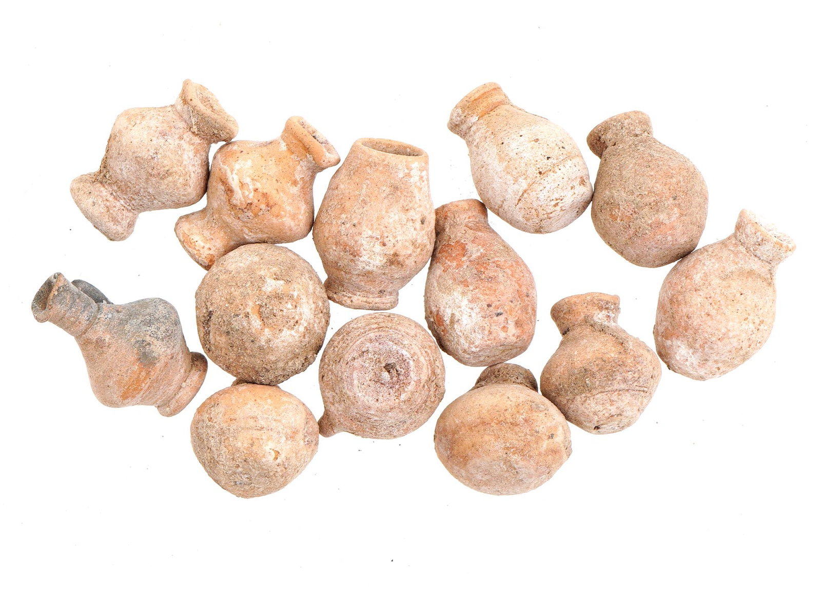 ANCIENT ROMAN TERRACOTTA TOY VESSELS OF VARIOUS SHAPES: A group of ancient Roman terracotta miniature toy vessels, dating from 100 to 300 AD. These small-scale vessels exhibit different designs, reflecting the craftsmanship and playful aspects of Roman cul