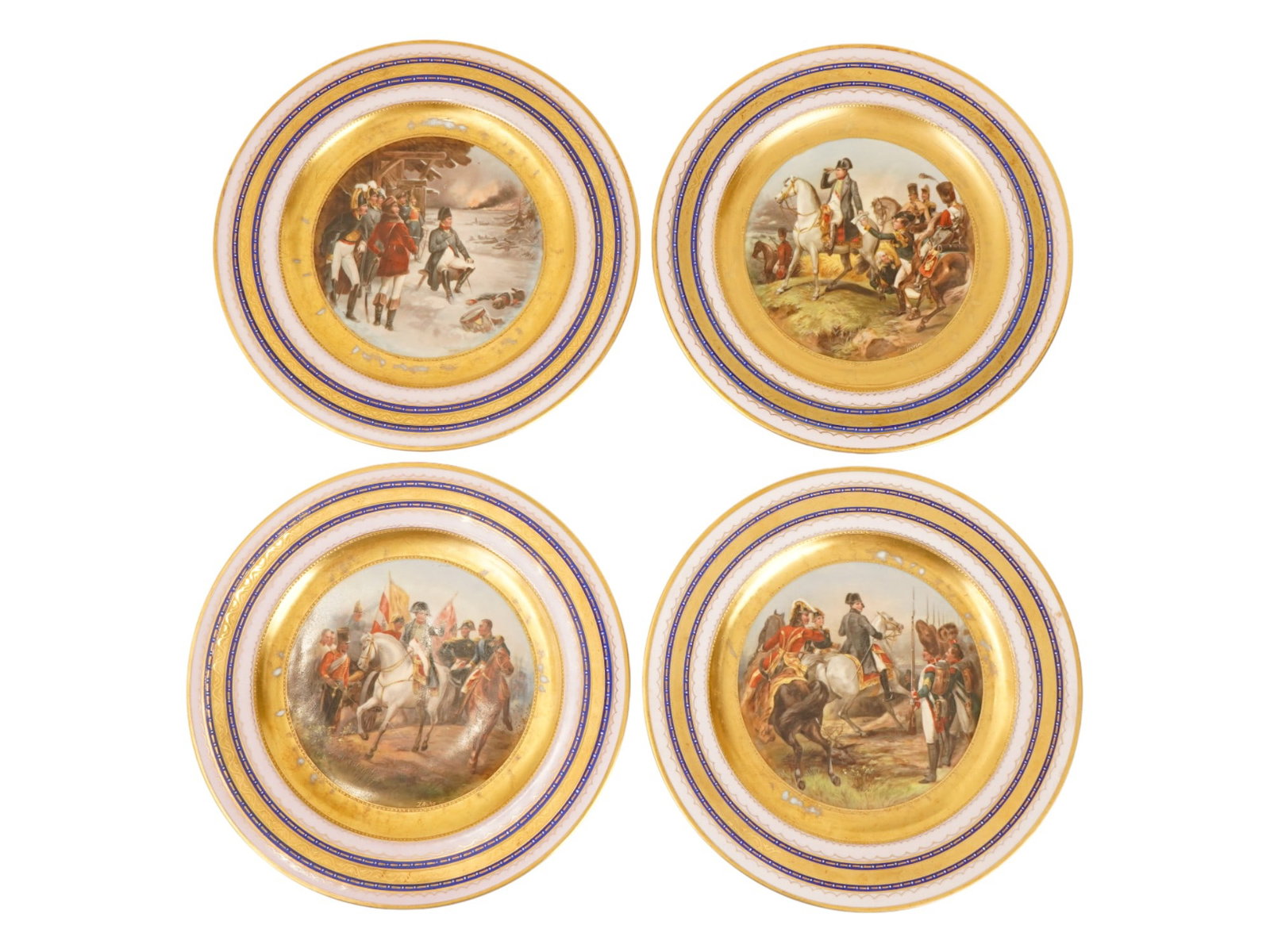 AUSTRIAN ROYAL VIENNA NAPOLEON PORCELAIN PLATES SET: A collection of four Austrian Royal Vienna hand enamelled porcelain plates. The plates depict various scenes depicting Napoleon campaign scenes. The plates are decorated with gilded and cobalt blue bo
