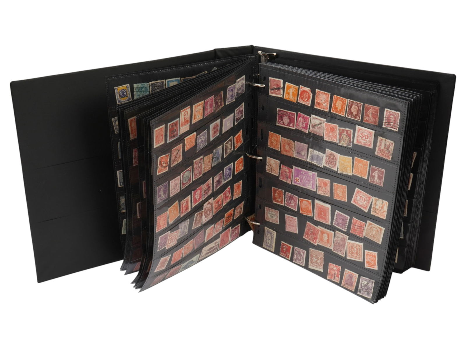COLLECTION OF VINTAGE POSTAGE STAMPS IN ALBUM: A collection of vintage postage stamps from various countries collected in a stamp album. Collectible Postage Stamps, Historical Memorabilia, Philately. THIS LOT IS ELIGIBLE FOR A 30-DAY UNCON