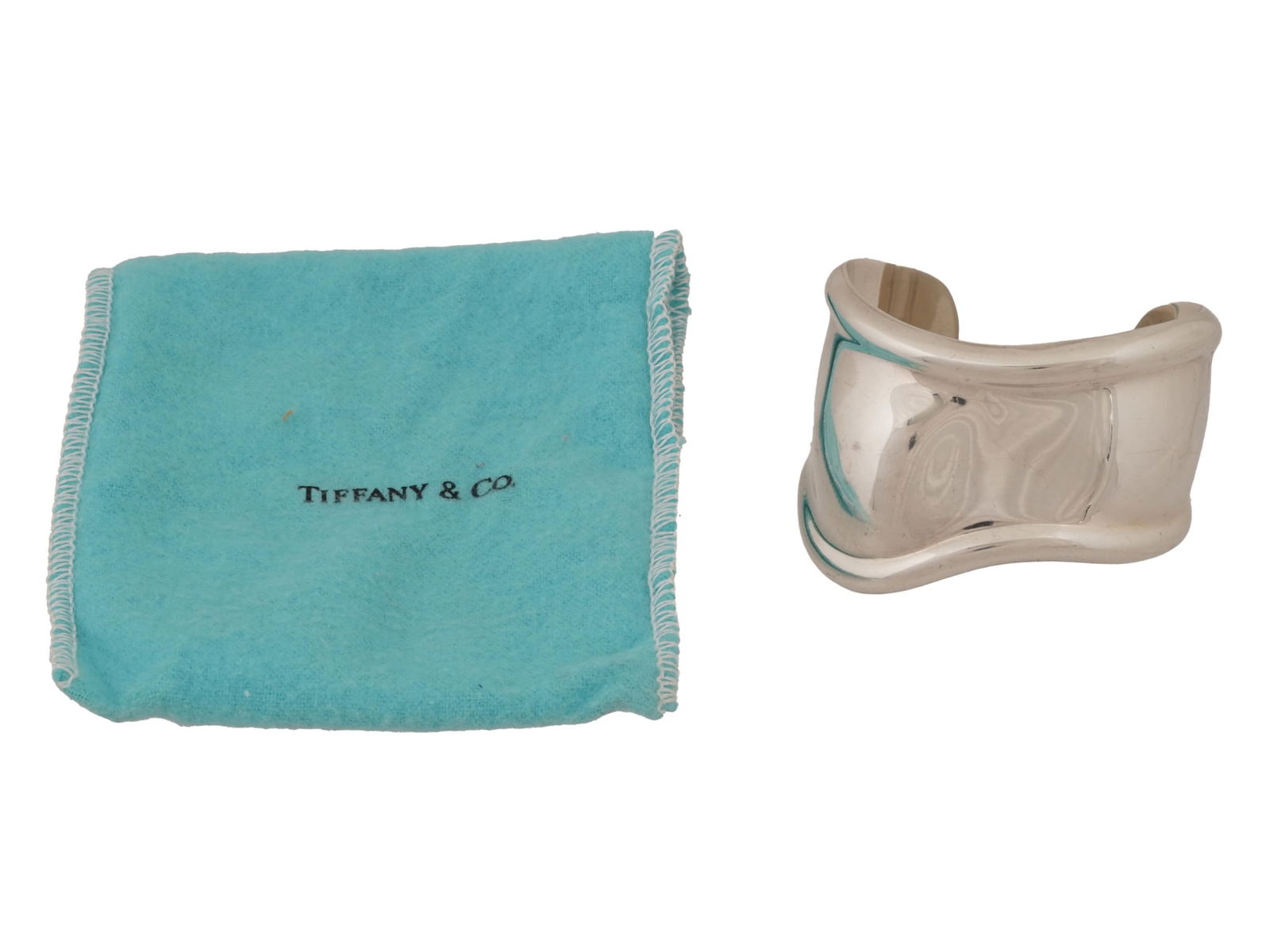 ELSA PERETTI FOR TIFFANY STERLING SILVER BRACELET: A sterling silver Bone Cuff bracelet by Tiffany and Co. Design by Elsa Peretti, 1940 to 2021, an Italian jewelry designer. Marked Peretti, Tiffany and Co., Italy, 1978, Sterling, 925 on the backside.