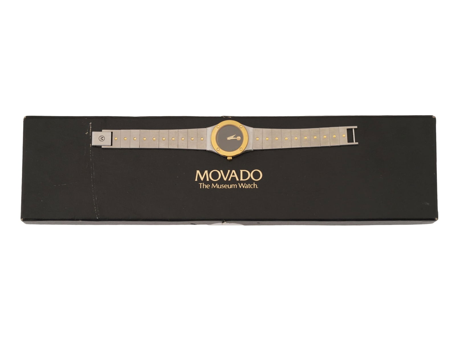 MOVADO MUSEUM LADIES STAINLESS STEEL WRISTWATCH IOB: A vintage womens stainless steel wristwatch by Movado. Museum collection Quartz movement. Water resistant. Round case with gilt bezel and single crown. Black dial with a gilt round index at 12 o clock