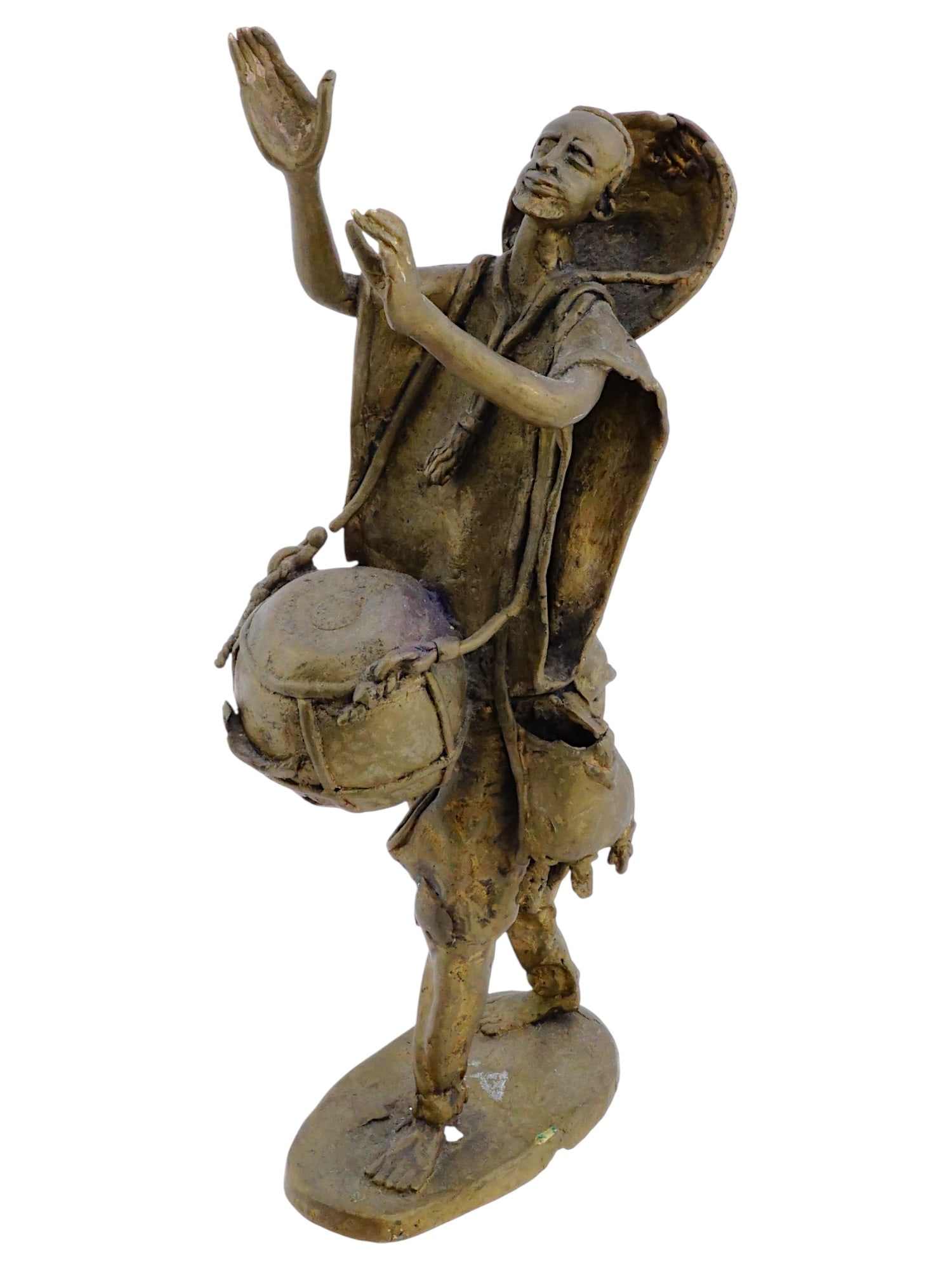 VINTAGE WEST AFRICAN BURKINA FASO METAL SCULPTURE: A vintage West African Burkina Faso metal sculpture. Circa mid to late 20th century. The sculpture, raised on a base, depicts a drummer walking with a drum in a dynamic pose. African Sculptures of Mus