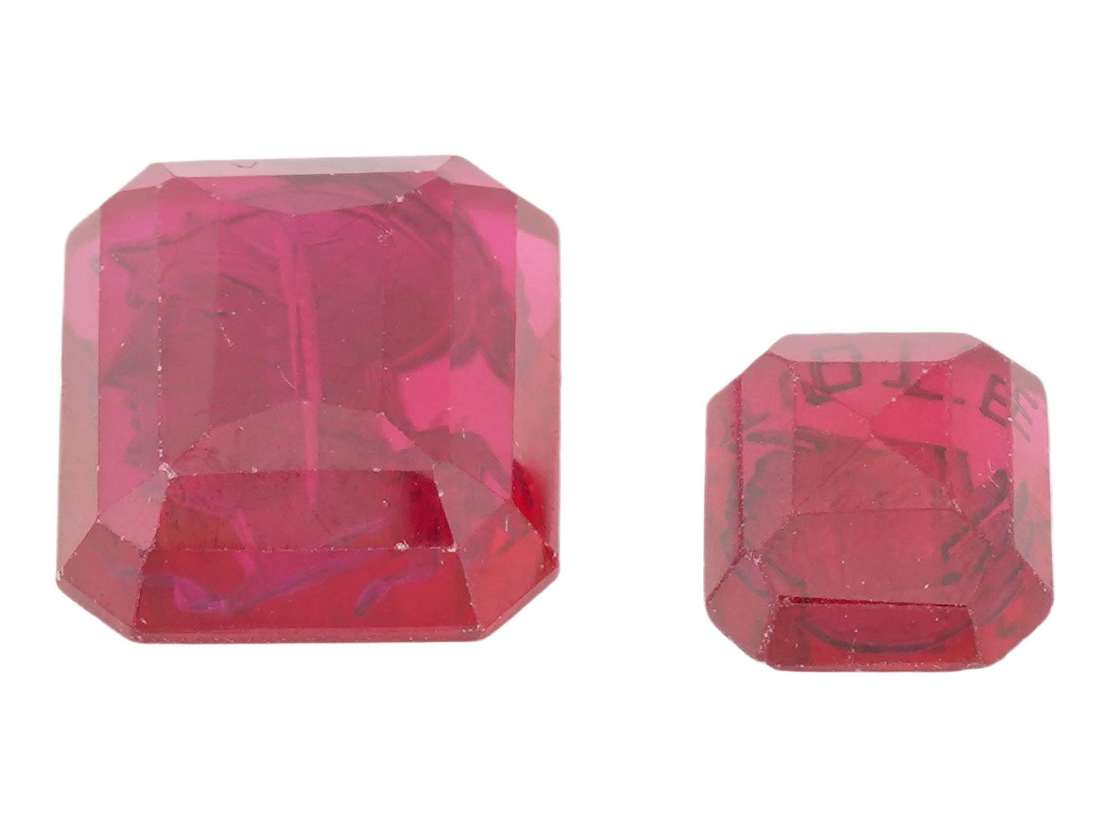 VINTAGE INTAGLIOS NATIVE AMERICAN AND ROMAN PROFILES: Two vintage intaglios. One features a Native American profile etched into a red material and includes the word TOTE etched beneath the profile, referencing the Fraternal Order of Red Men, a North Amer