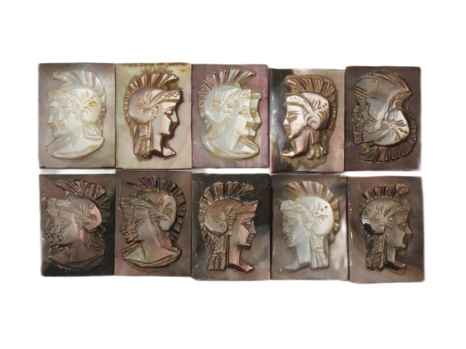 ANTIQUE VINTAGE GRECO ROMAN PROFILE CARVED SHELL CAMEOS: A set of ten antique or vintage carved shell cameos, each depicting the head profile of a Greco-Roman figure wearing a crested helmet. Carved from a mother of pearl or abalone shell, the pieces displa